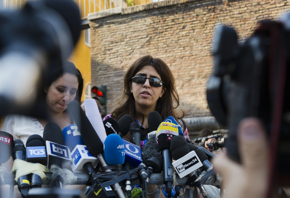 Italian communications expert Francesca Chaouqui talks to journalists July 7, 2016, after a Vatican court convicted her and a Vatican monsignor for having conspired to pass documents to two Italian journalist. A Vatican trial into a money-losing investment has been jolted by revelations that a key prosecution witness was apparently manipulated into changing his story and cooperating with prosecutors. (AP Photo/Domenico Stinellis, File)