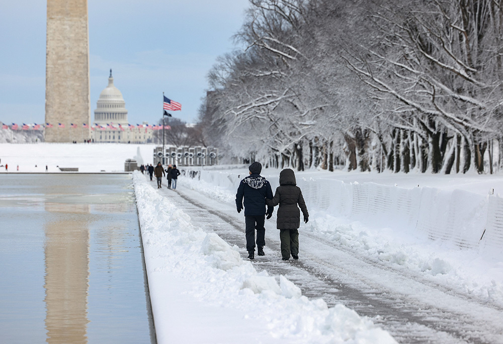 People in Washington walk along the National Mall following a snowstorm Jan. 3, 2022. (CNS/Reuters/Evelyn Hockstein) People in Washington walk along the National Mall following a snowstorm Jan. 3, 2022. (CNS/Reuters/Evelyn Hockstein)