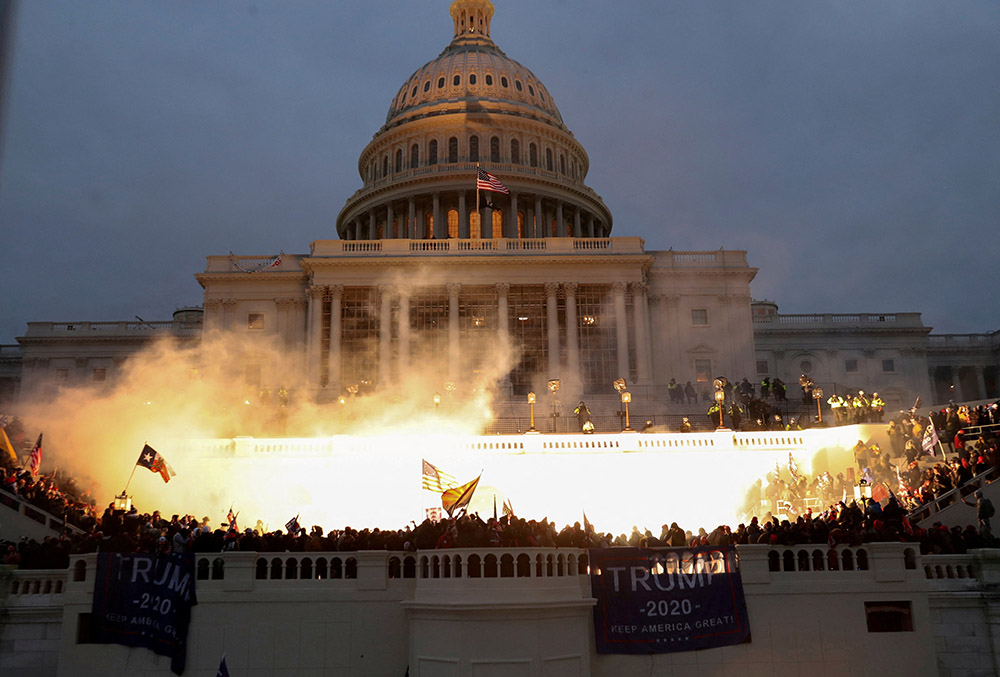 An explosion caused by a police munition is seen while supporters of then-President Donald Trump gather in front of the U.S. Capitol Building in Washington on Jan. 6, 2021. (CNS/Reuters/Leah Millis)