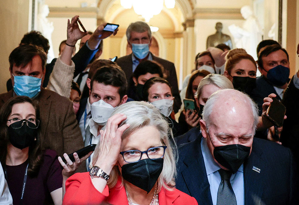 Rep. Liz Cheney, R-Wyo., and her father, former Vice President Dick Cheney, are pursued by reporters after attending a moment of silence event on Capitol Hill Jan. 6 in Washington, the first anniversary of the attack on the U.S. Capitol. (CNS) Rep. Liz Cheney, R-Wyo., and her father, former Vice President Dick Cheney, are pursued by reporters after attending a moment of silence event on Capitol Hill Jan. 6 in Washington, the first anniversary of the attack on the U.S. Capitol. (CNS)