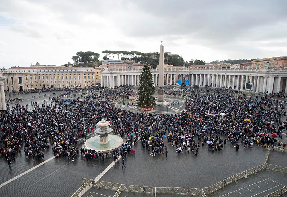 People in St. Peter's Square attend the Angelus led by Pope Francis from the window of his studio overlooking the square at the Vatican Jan. 6, the feast of the Epiphany. (CNS/Vatican Media)