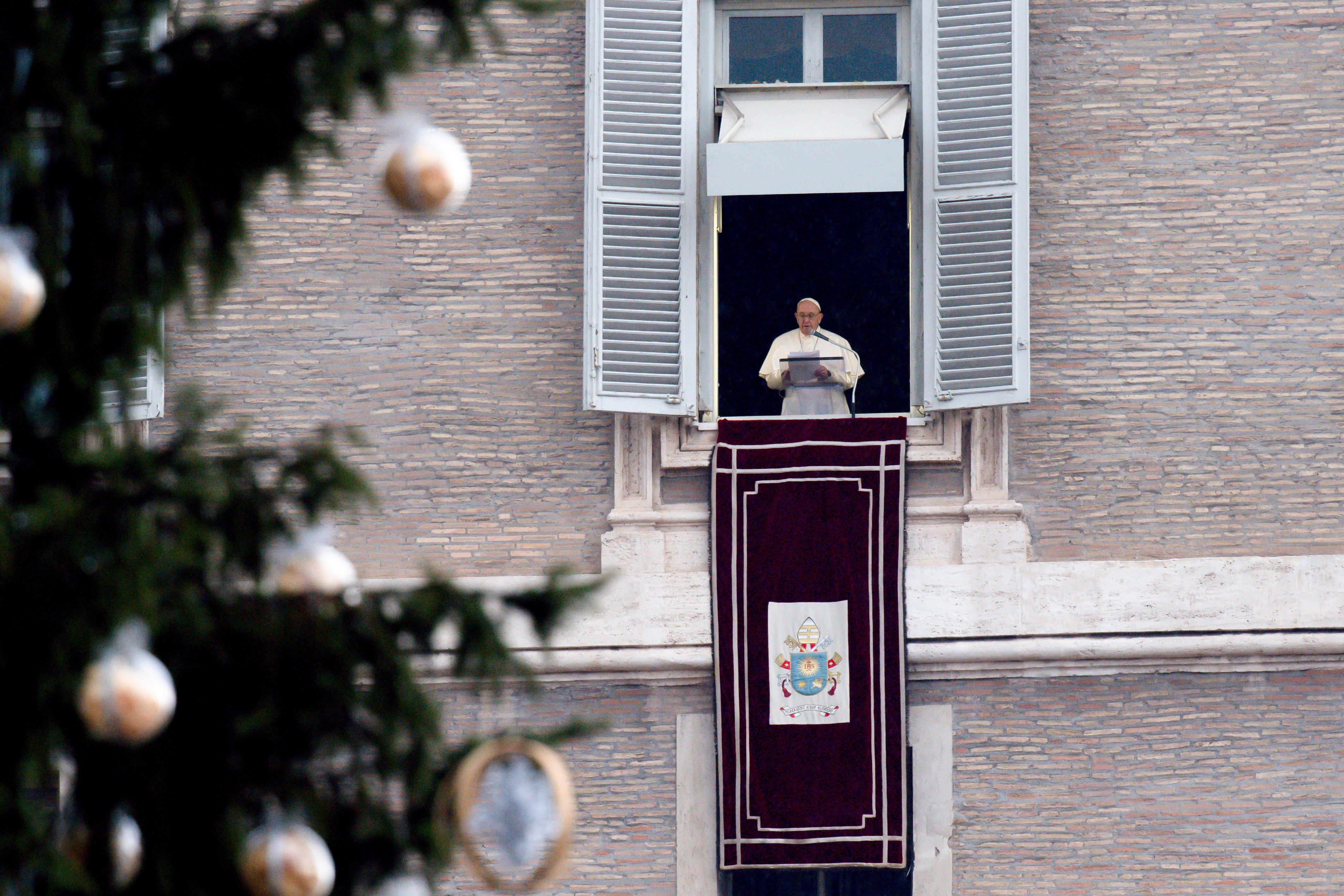 The Christmas tree is seen as Pope Francis leads the Angelus from the window of his studio overlooking St. Peter's Square at the Vatican Jan. 9, 2022. (CNS photo/Vatican Media)