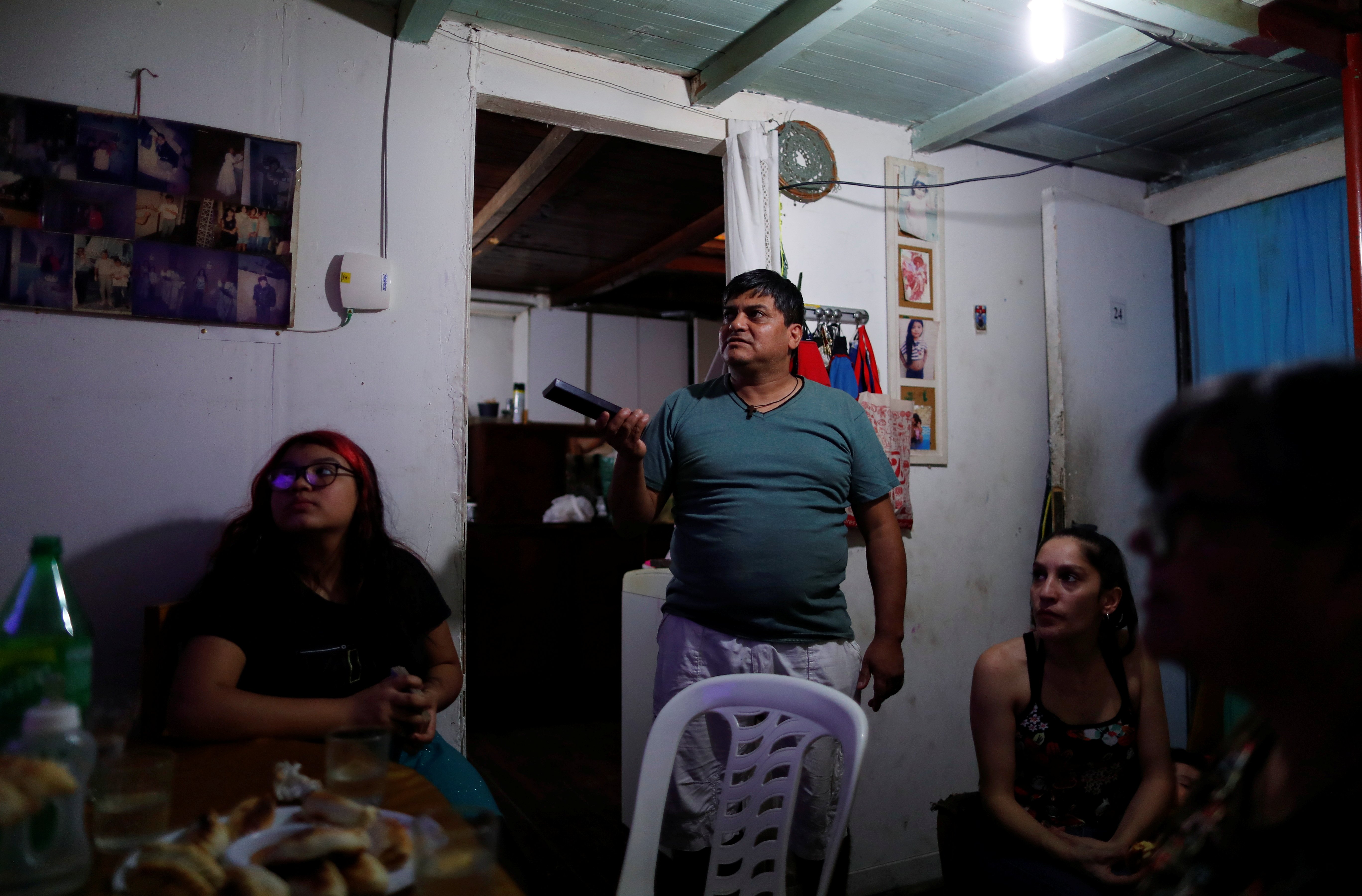 Gustavo Delgado, 52, who lost his job during the COVID-19 outbreak, celebrates his daughter's 12th birthday at home in Buenos Aires, Argentina, in this Nov. 17, 2020. (CNS photo/Agustin Marcarian, Reuters)