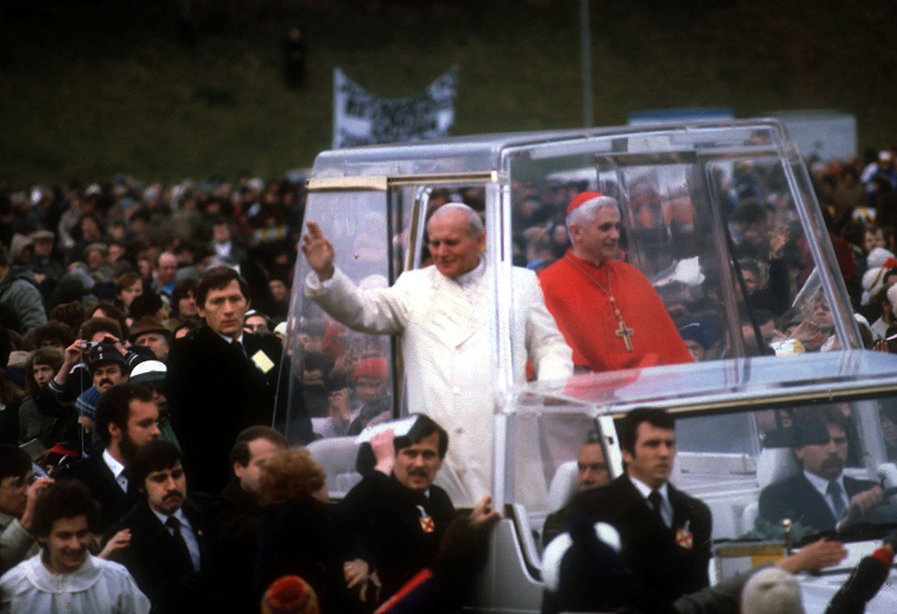 St. John Paul II and Cardinal Joseph Ratzinger ride in the popemobile during a visit to Germany in 1980. The cardinal -- now retired Pope Benedict XVI -- headed the Archdiocese of Munich 1977-1981. (CNS photo/KNA)