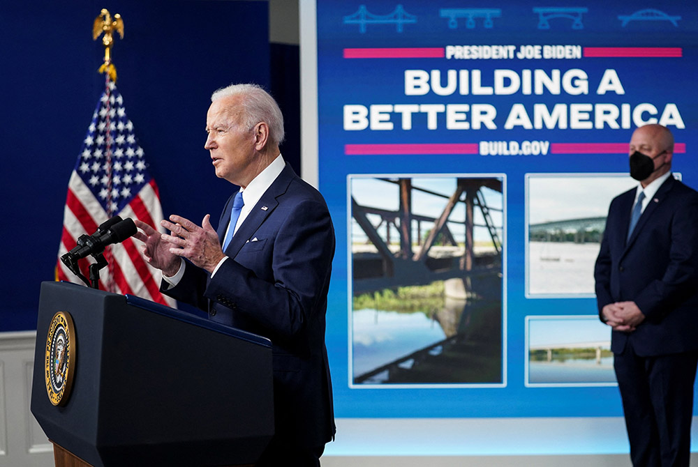 President Joe Biden delivers remarks at the White House in Washington Jan. 14. Also pictured is Mitch Landrieu, senior adviser on infrastructure. (CNS/Reuters/Kevin Lamarque)