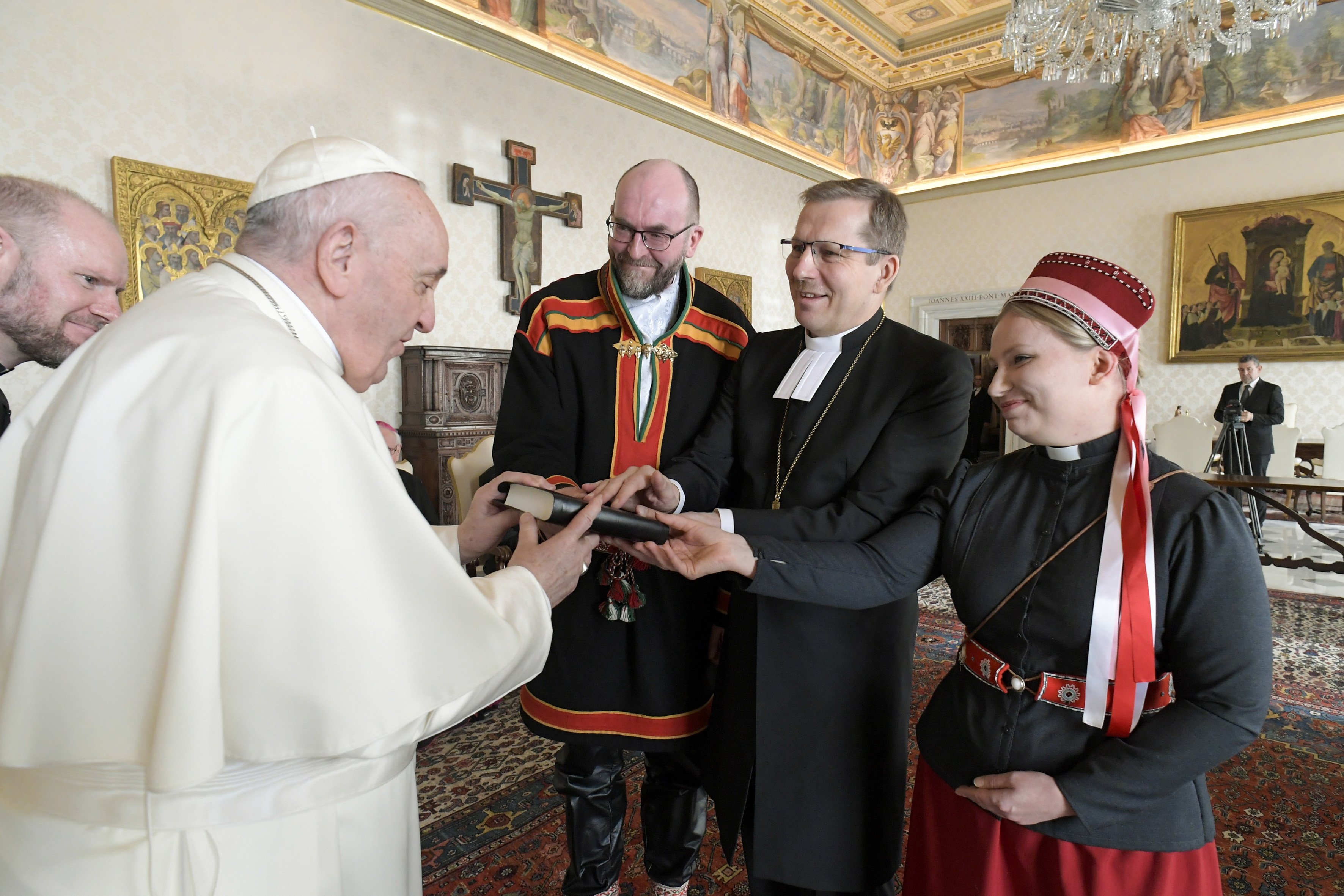 Pope Francis accepts a gift during an audience with an ecumenical delegation from Finland at the Vatican Jan. 17, 2022.  (CNS photo/Vatican Media)