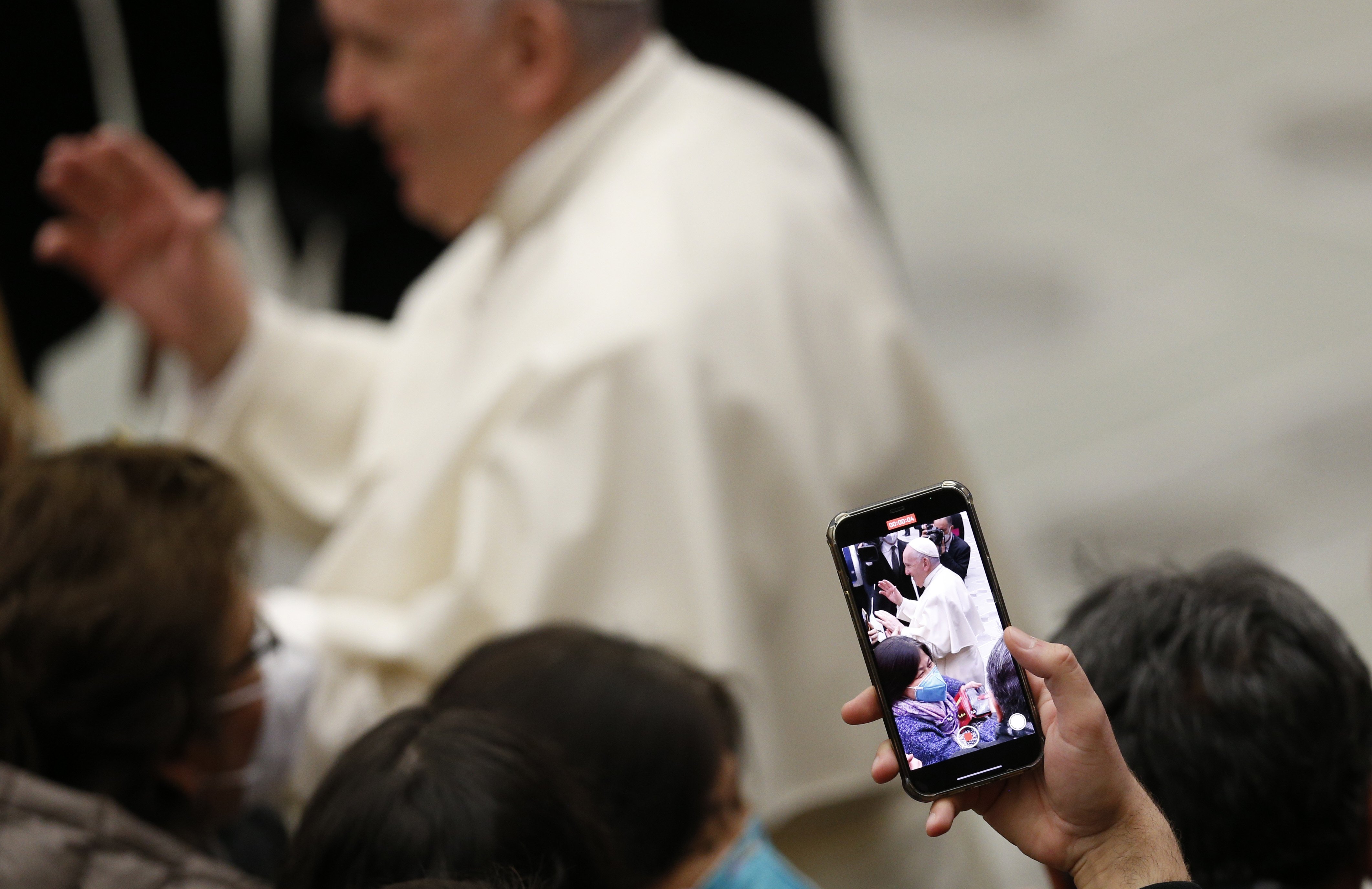 Pope Francis is pictured on a smart phone as he greets people during his general audience in the Paul VI hall at the Vatican Jan. 19, 2022. (CNS photo/Paul Haring)