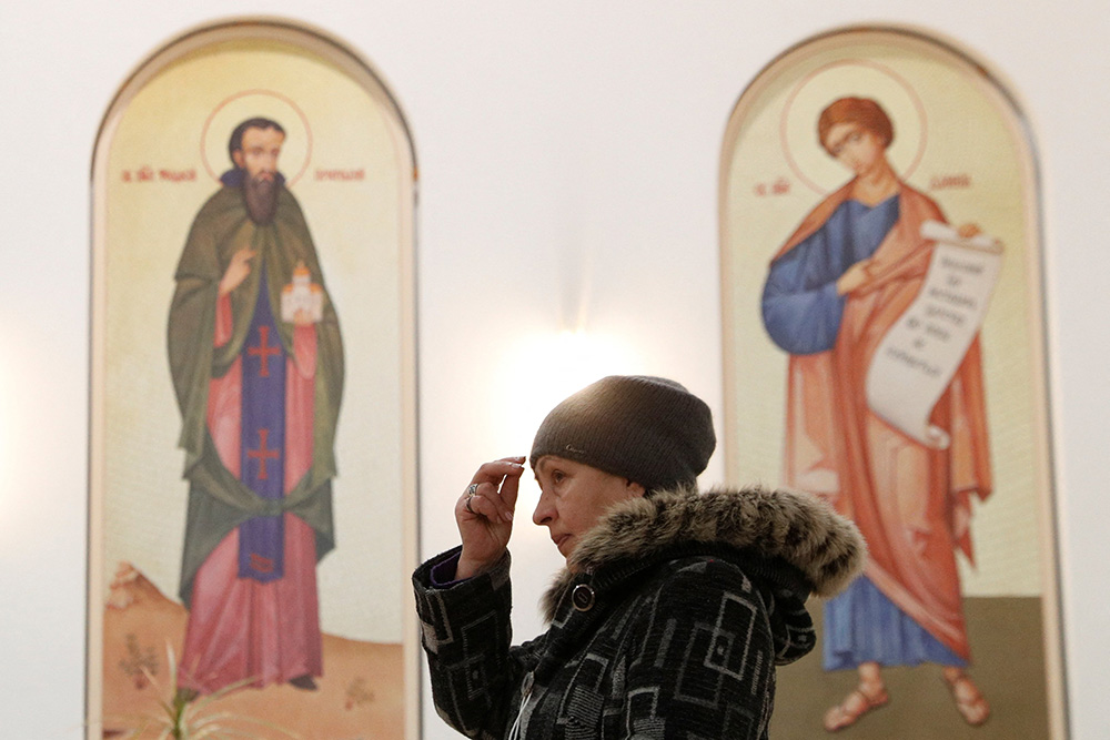 A believer attends a liturgy at the Ukrainian Greek Catholic Cathedral of the Resurrection of Christ in Kyiv, Ukraine, Jan. 26. (CNS/Reuters/Valentyn Ogirenko)