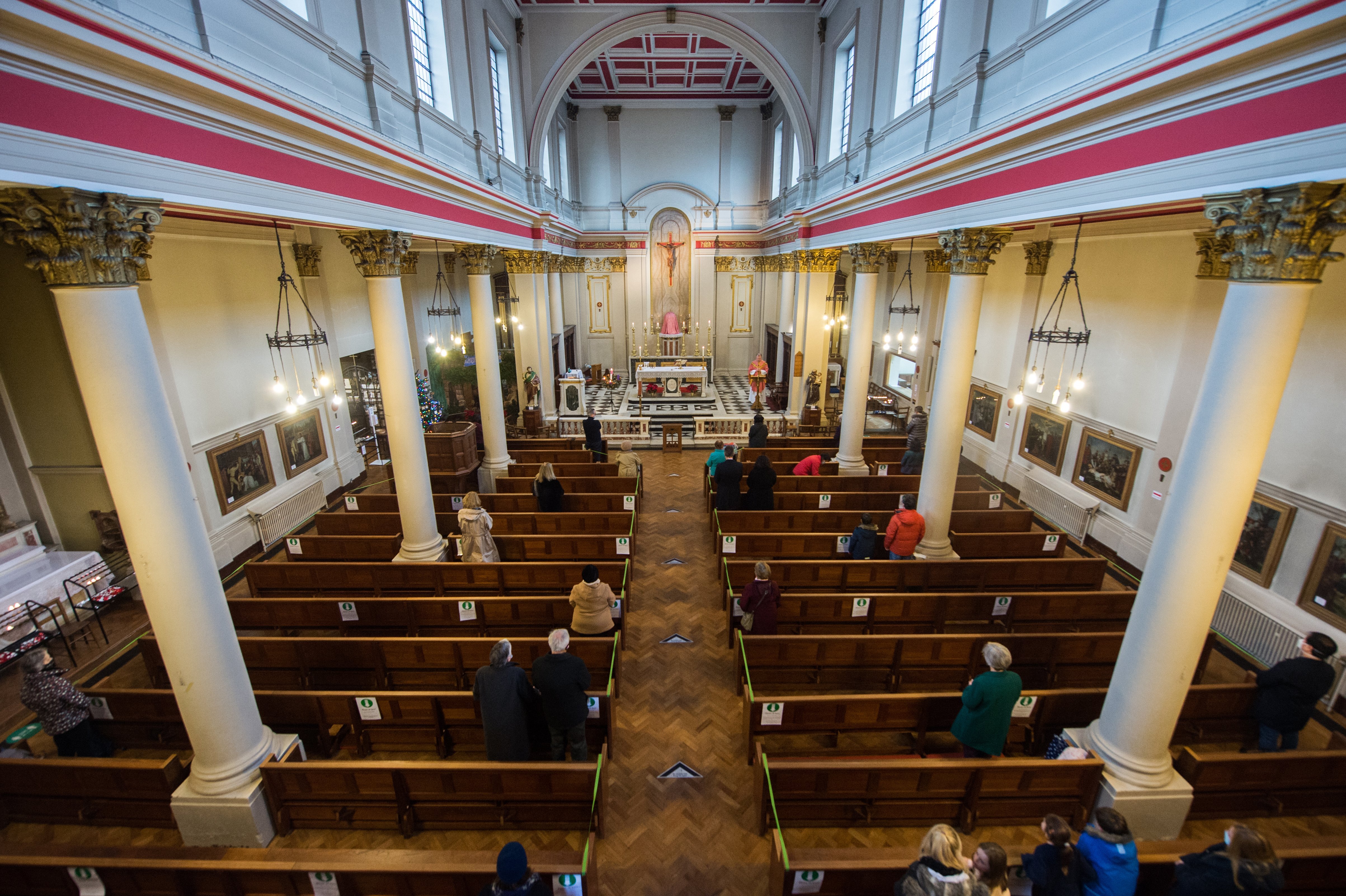 People maintain social distancing while attending Mass in the Church of Our Lady of Grace & St. Edward in London Dec. 13, 2020. (CNS photo/Marcin Mazur, courtesy Bishops' Conference of England and Wales)