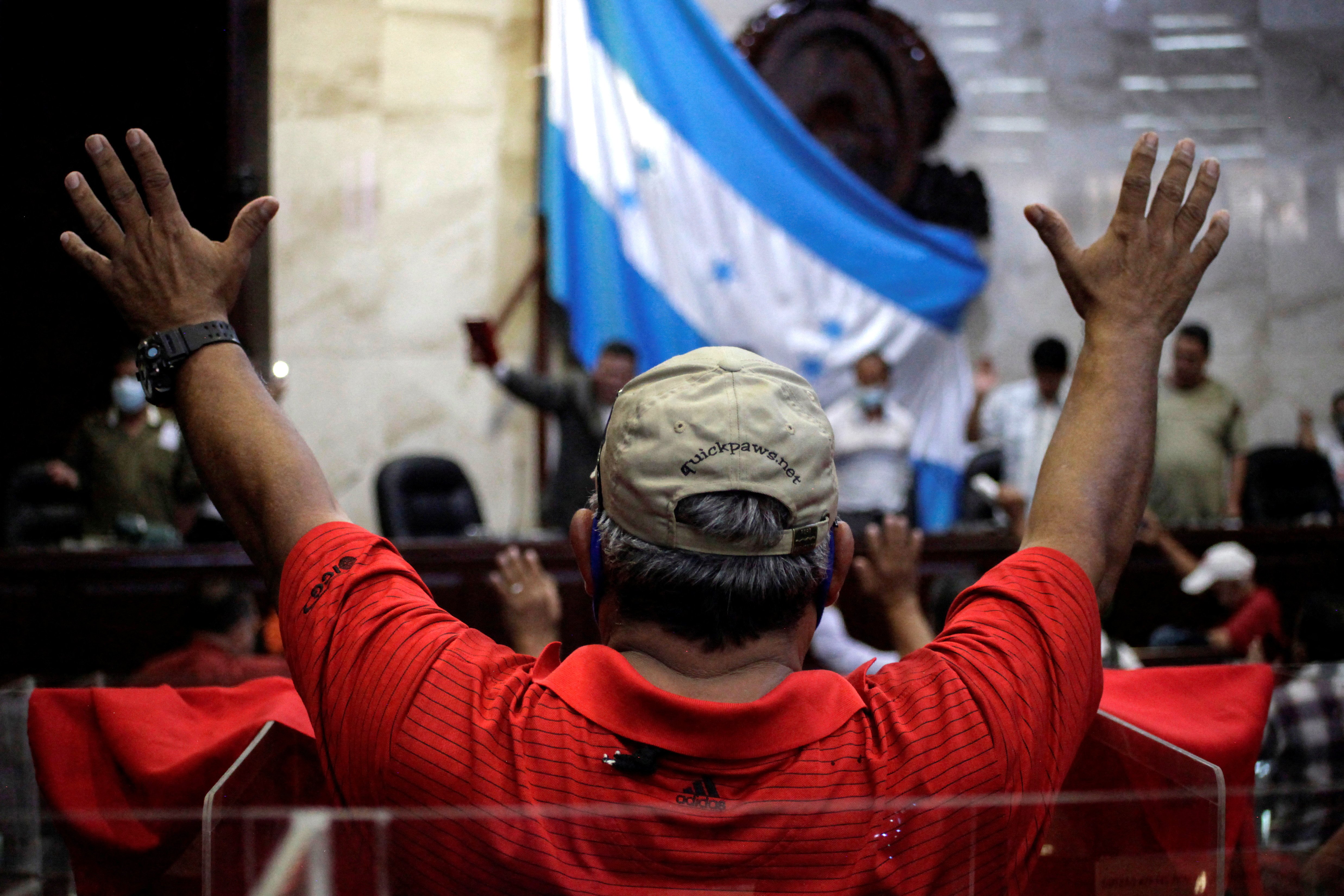Supporters of Honduran President-elect Xiomara Castro pray inside the National Congress after the installation of the new Congress in Tegucigalpa Jan. 25, 2022. (CNS photo/Fredy Rodriguez, Reuters)