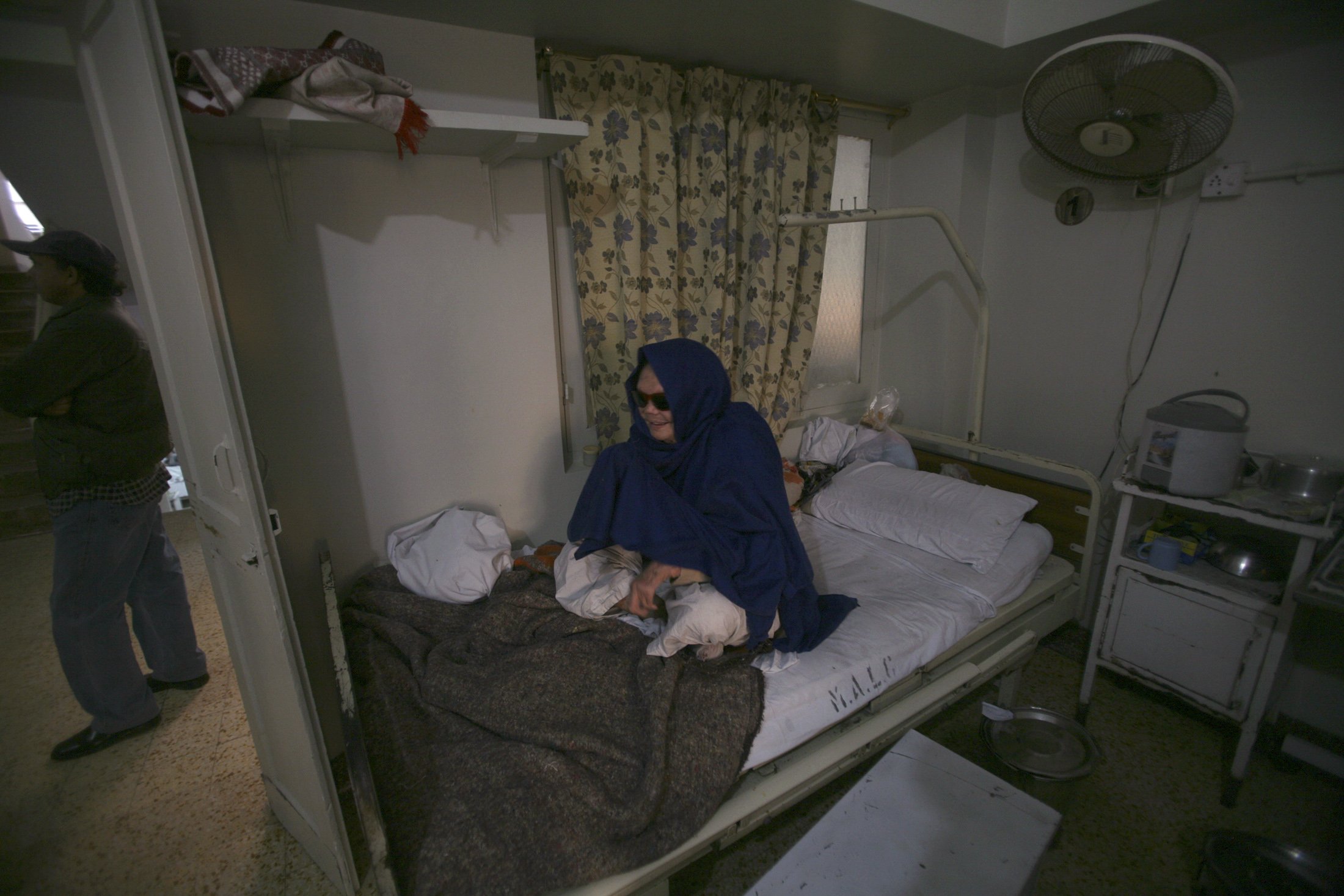 A patient sits on her bed at Marie Adelaide Leprosy Center in Karachi, Pakistan, in this Jan. 25, 2008. (CNS photo/Athar Hussain, Reuters)
