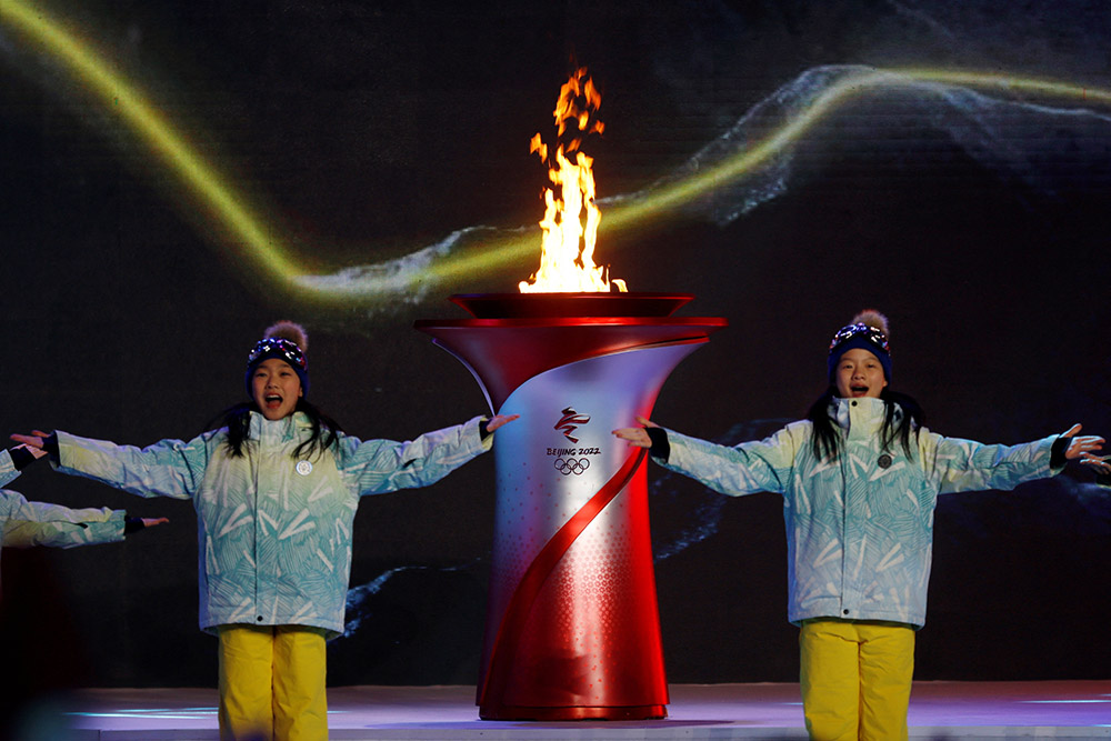 Actors perform next to a cauldron with the Olympic flame during a performance at the end of the torch relay session ahead of the Beijing 2022 Winter Olympics Feb. 2. (CNS/Reuters/Florence Lo)