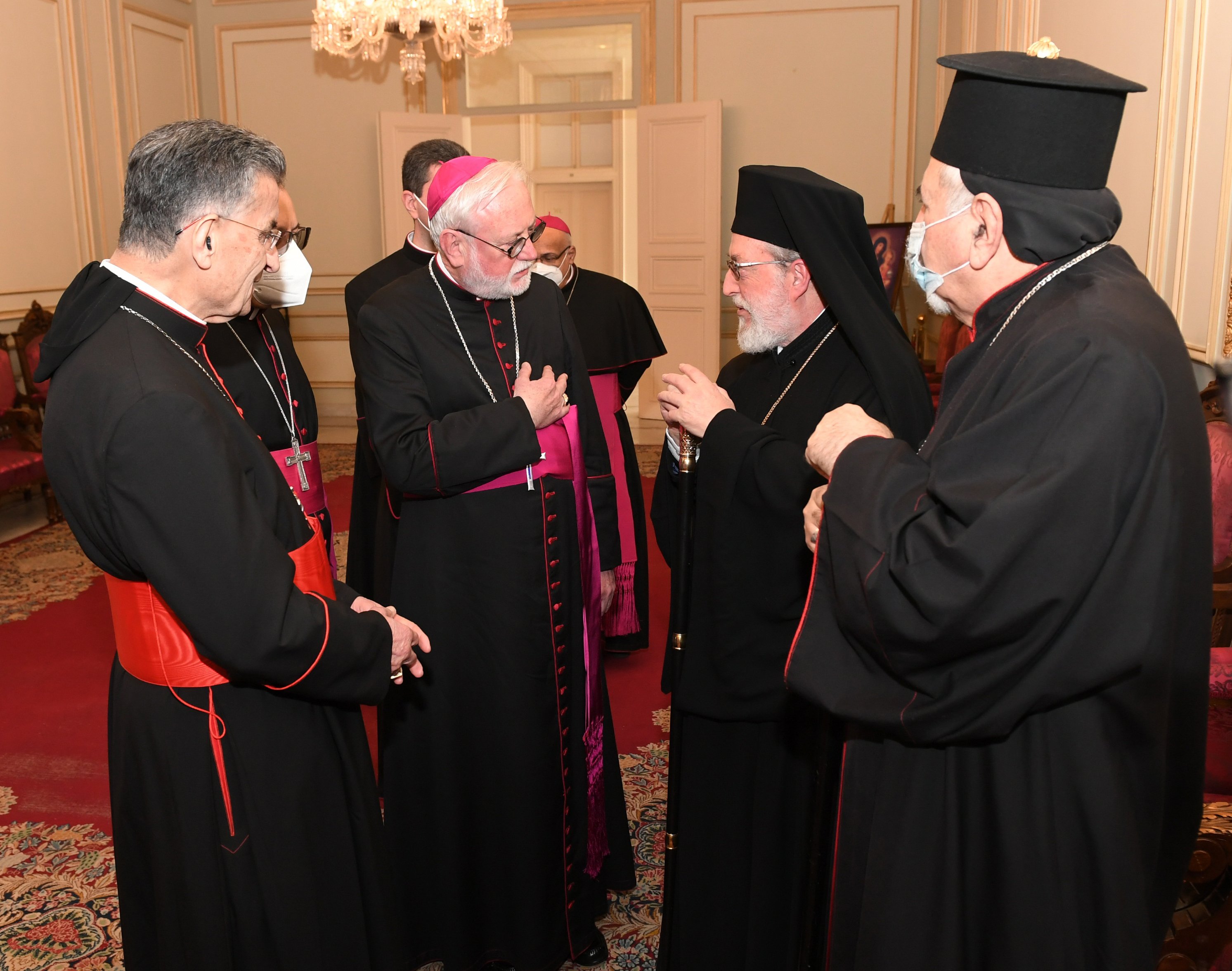 Archbishop Paul Gallagher, Vatican foreign minister, center, speaks with Metropolitan Elias Kfoury, representing Greek Orthodox Patriarch John X, Feb. 2, as they attend the monthly meeting of the Maronite Catholic bishops at Bkerke, near Beirut. (CNS)
