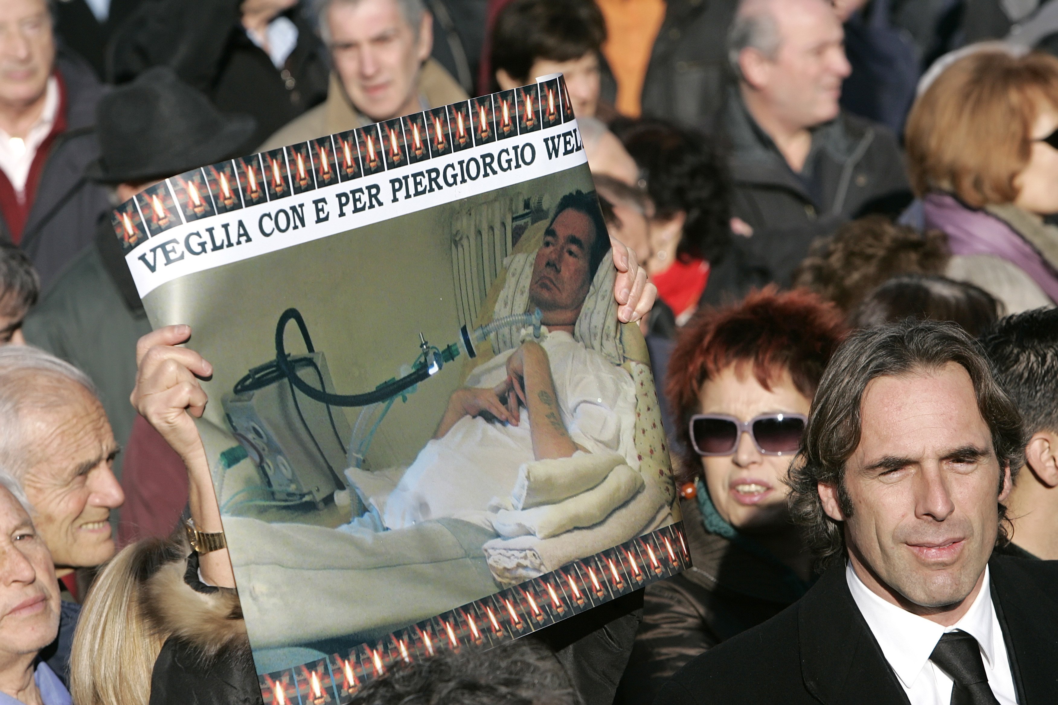 Mourners hold a picture of Piergiorgio Welby during his funeral in Rome in this Dec. 24, 2006. (CNS photo/Max Rossi)
