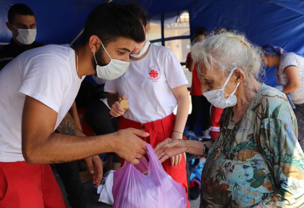 Caritas Youth volunteers are pictured in an undated photo distributing clothing in the aftermath of the Aug. 4, 2020, Beirut blast. (CNS/Caritas Lebanon) Caritas Youth volunteers are pictured in an undated photo distributing clothing in the aftermath of the Aug. 4, 2020, Beirut blast. (CNS/Caritas Lebanon)