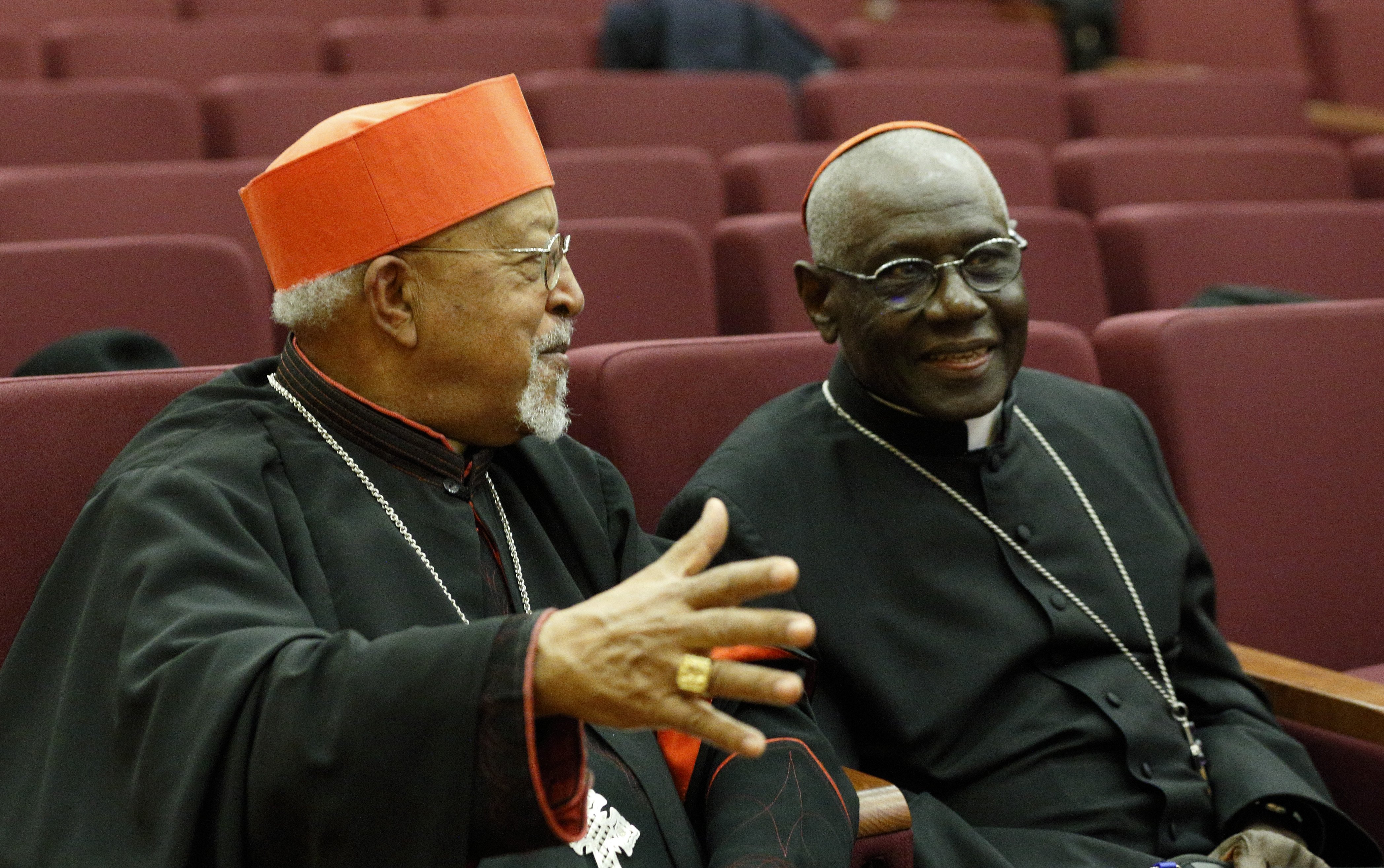 Cardinal Berhaneyesus Souraphiel of Addis Ababa, Ethiopia, and Cardinal Robert Sarah, talk during a meeting hosted by the Vatican Congregation for Eastern Churches in Rome Feb. 16, 2022. (CNS photo/Paul Haring)