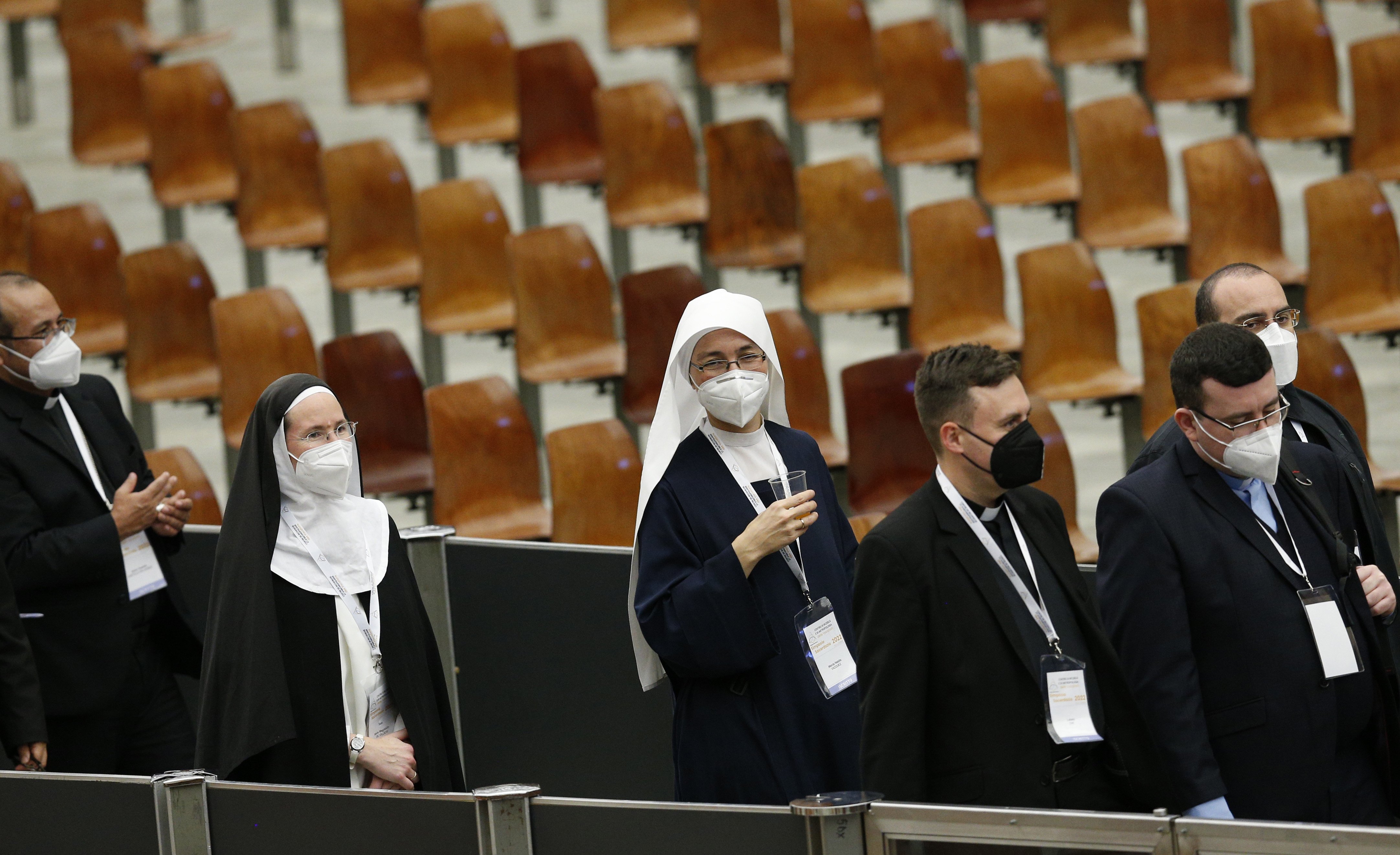 Participants return to their seats after a break during an international symposium on the priesthood at the Vatican Feb. 17, 2022. (CNS photo/Paul Haring)
