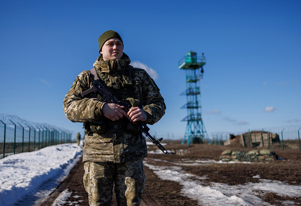 A Ukrainian frontier guard patrols an area along the Ukrainian-Russian border Feb. 23 in the Kharkiv, Ukraine. (CNS/Reuters/Antonio Bronic) A Ukrainian frontier guard patrols an area along the Ukrainian-Russian border Feb. 23 in the Kharkiv, Ukraine. (CNS/Reuters/Antonio Bronic)