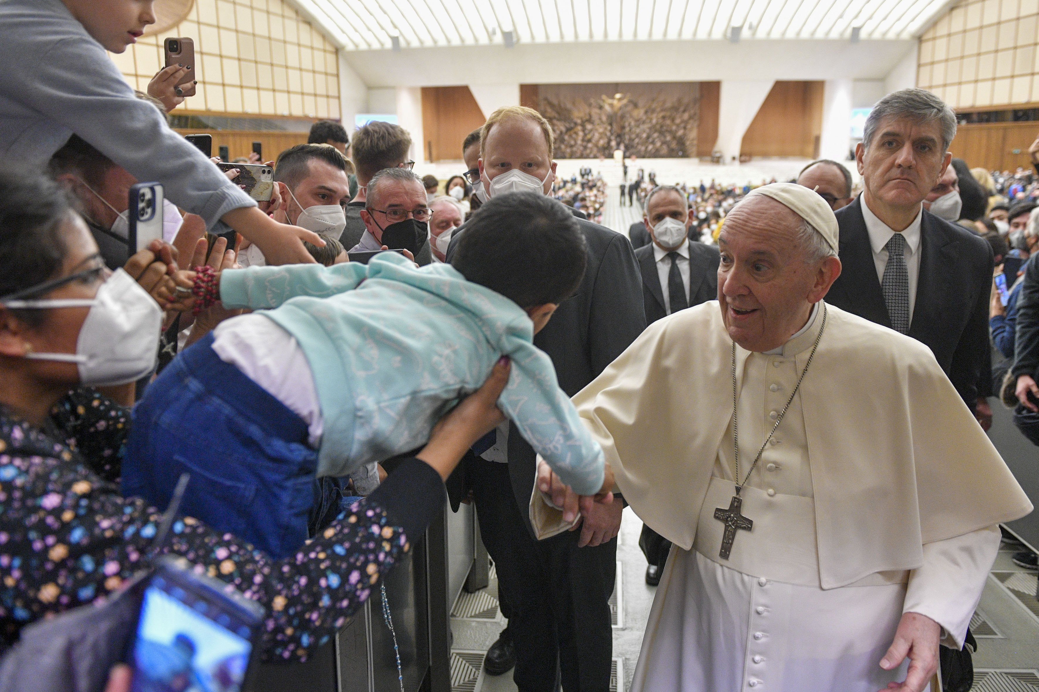 Pope Francis greets a child during his general audience in the Paul VI hall at the Vatican Feb. 23, 2022. (CNS photo/Paul Haring)