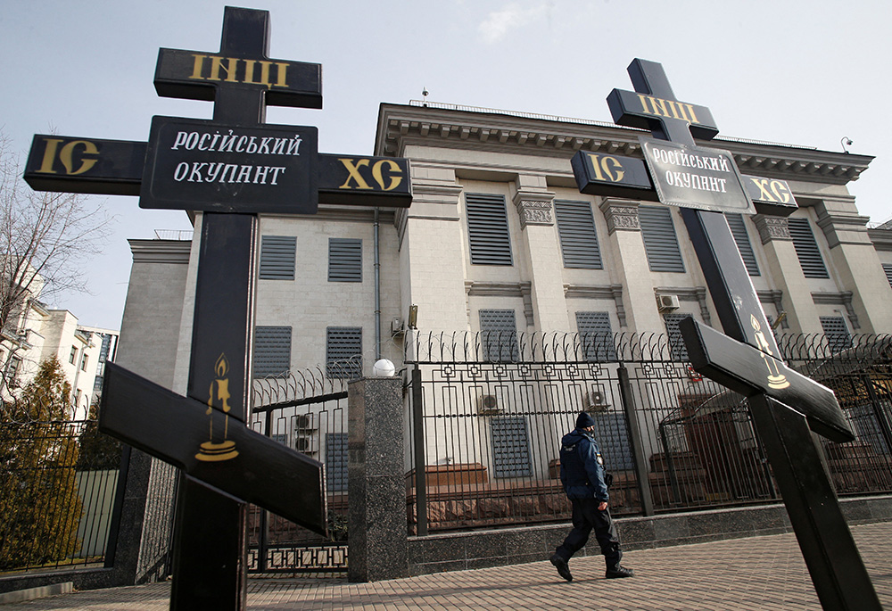 Crosses installed during a protest against Russia's actions in eastern Ukraine are pictured Feb. 23 in front of the Russian Embassy in Kyiv, Ukraine. The signs on the crosses read: "Russian occupier." (CNS/Reuters/Valentyn Ogirenko)
