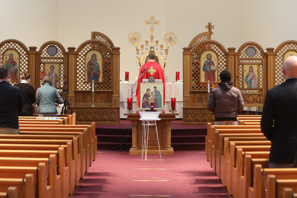 People pray during a morning Divine Liturgy at the Ukrainian Catholic National Shrine of the Holy Family in Washington Feb. 24 after Russia invaded Ukraine. (CNS/Bob Roller)