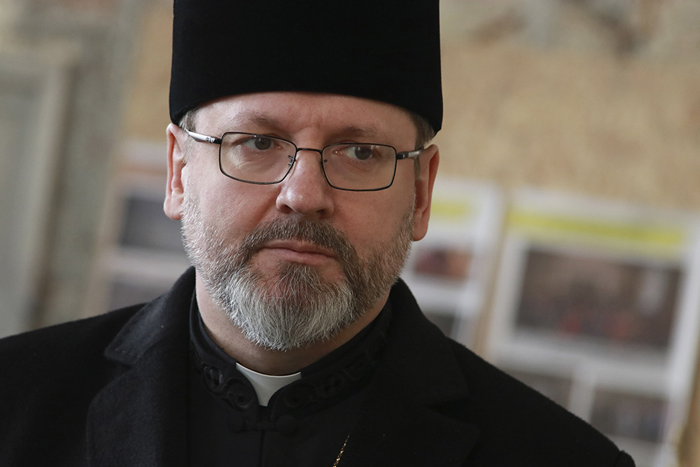 Archbishop Sviatoslav Shevchuk of Kyiv-Halych, head of the Eastern-rite Ukrainian Catholic Church, is pictured during a meeting with Ukrainian refugees in Lviv, Ukraine, March 10. He was joined in the visit by Cardinal Konrad Krajewski, the papal almoner.