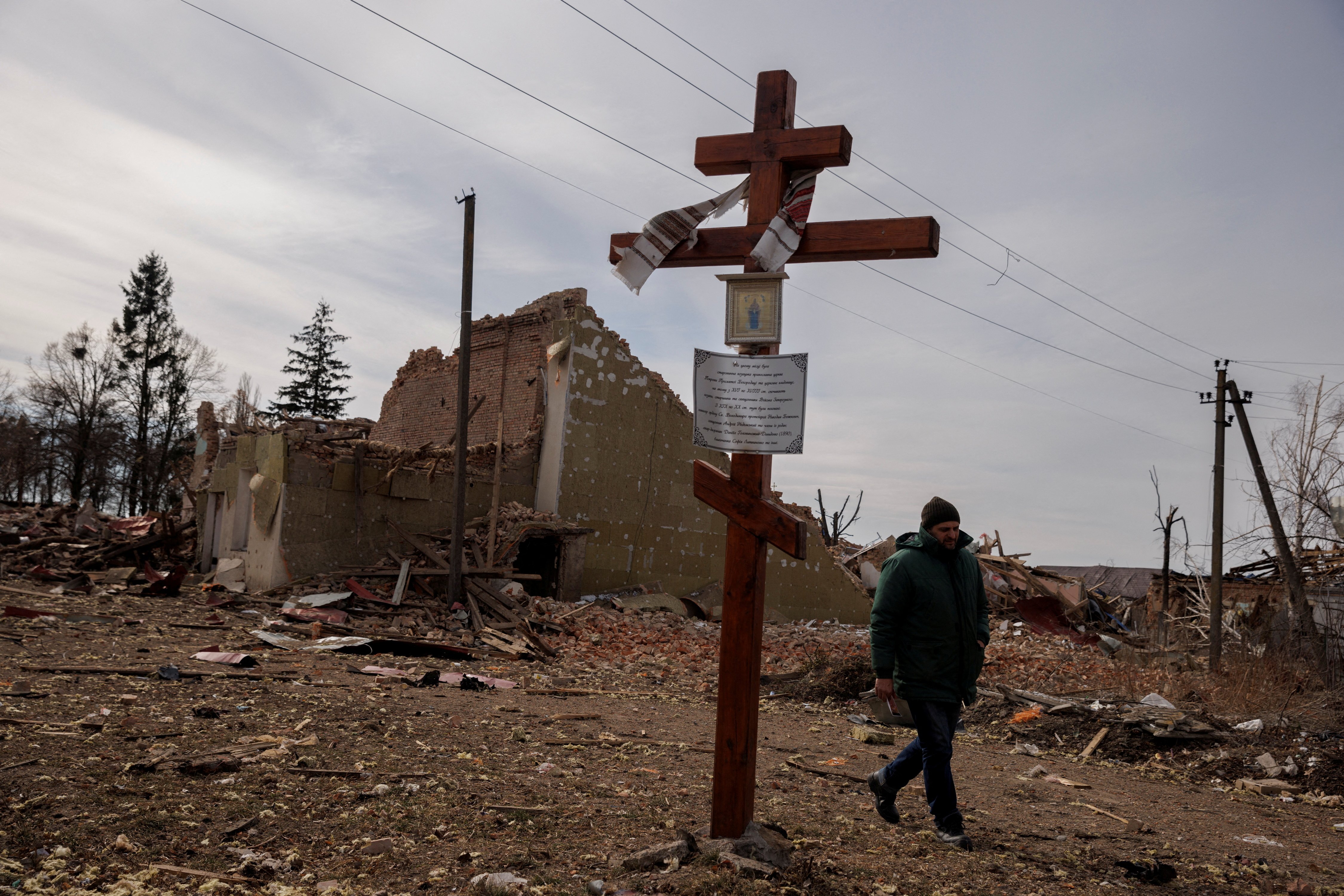 A man walks by the debris of a cultural center and an administration building destroyed during aerial bombing, as Russia's advance on the Ukrainian capital continues, in the village of Byshiv outside Kyiv, Ukraine, March 12, 2022. (CNS photo/Thomas Peter,