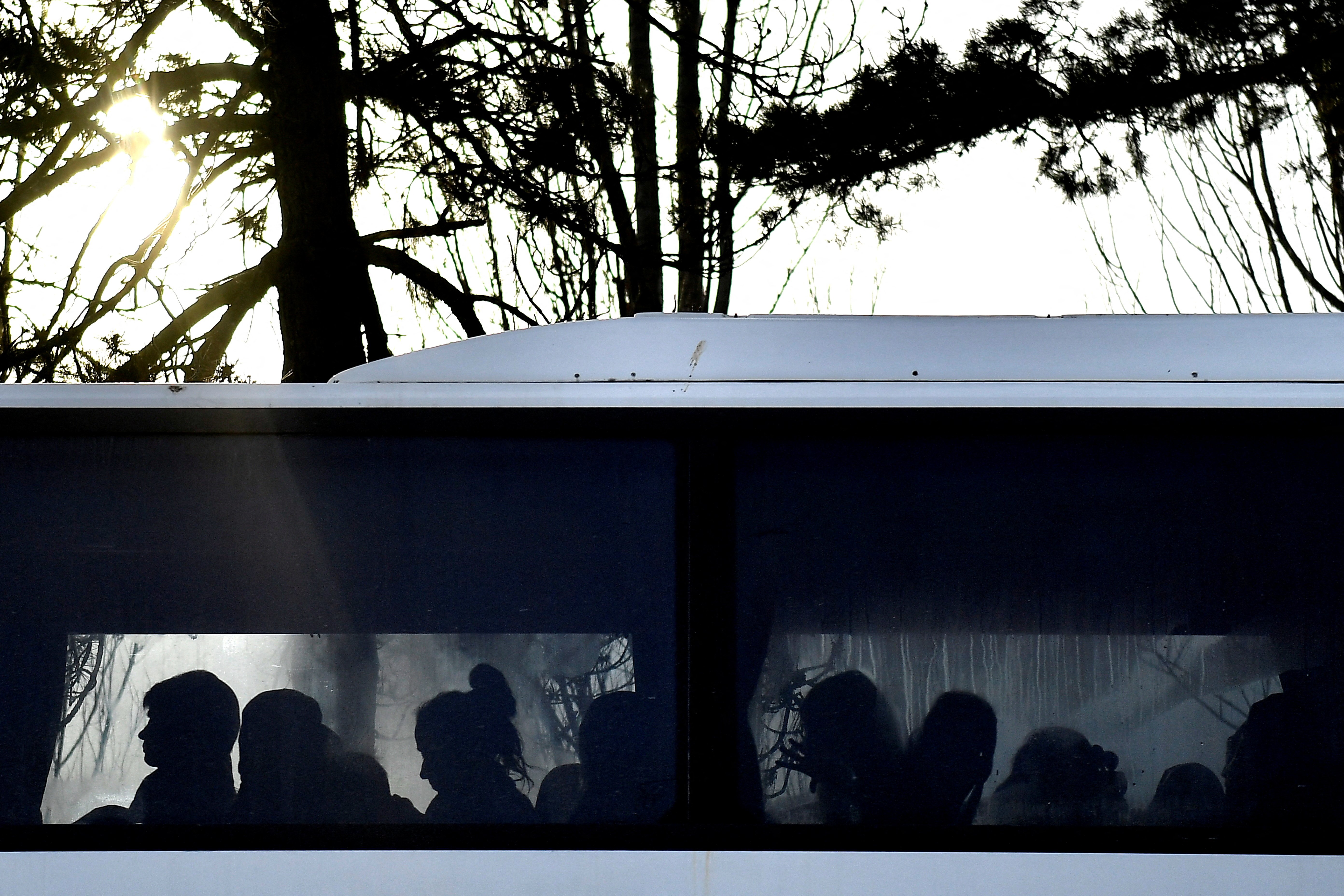 People sit on a bus after fleeing from Ukraine to Romania, following Russia's invasion of Ukraine, at the border crossing March 12 in Siret, Romania. (CNS/Reuters/Clodagh Kilcoyne)