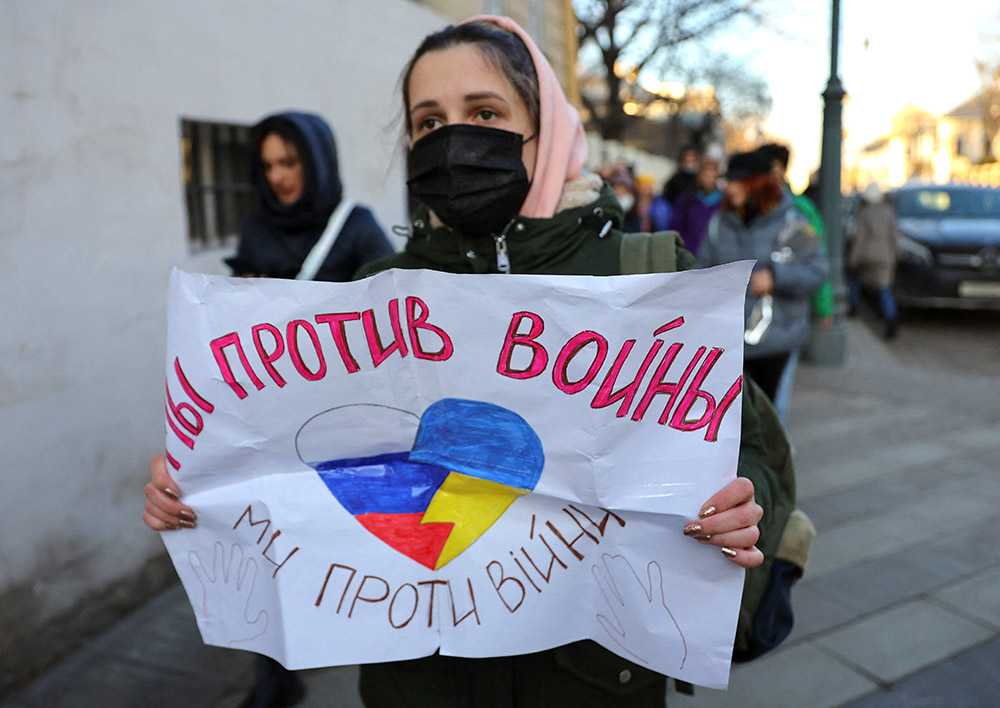 A young woman holds a sign that reads "We are against war" during a protest in Moscow Feb. 27, after Russia attacked Ukraine. (CNS/Reuters/Evgenia Novozhenina)