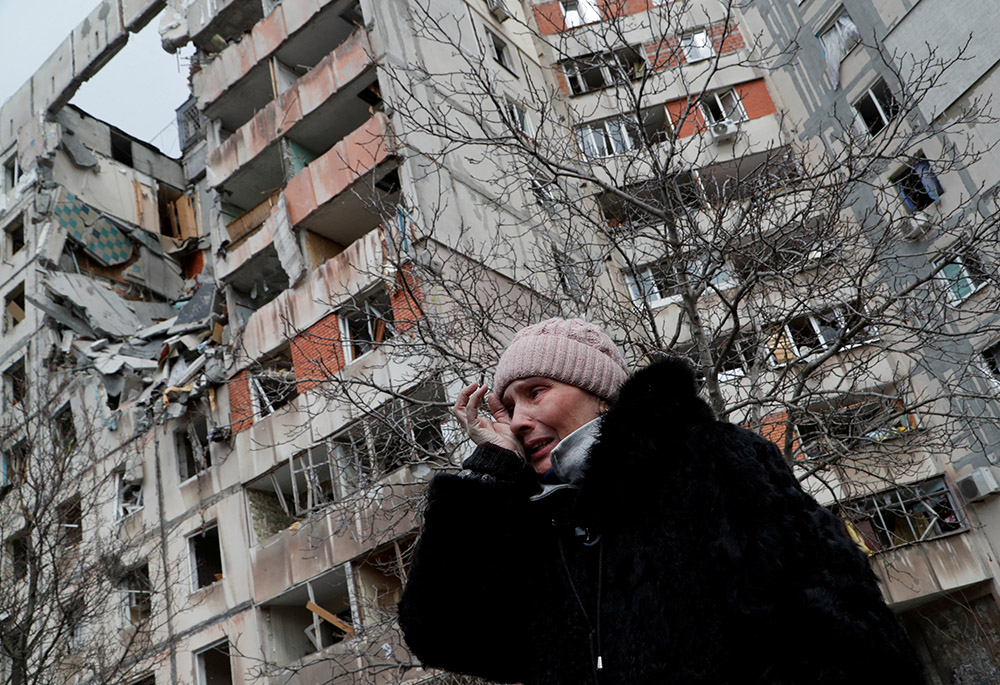 A woman reacts in front of destroyed apartment buildings March 17 in Mariupol, Ukraine. (CNS/Reuters/Alexander Ermochenko) A woman reacts in front of destroyed apartment buildings March 17 in Mariupol, Ukraine. (CNS/Reuters/Alexander Ermochenko)