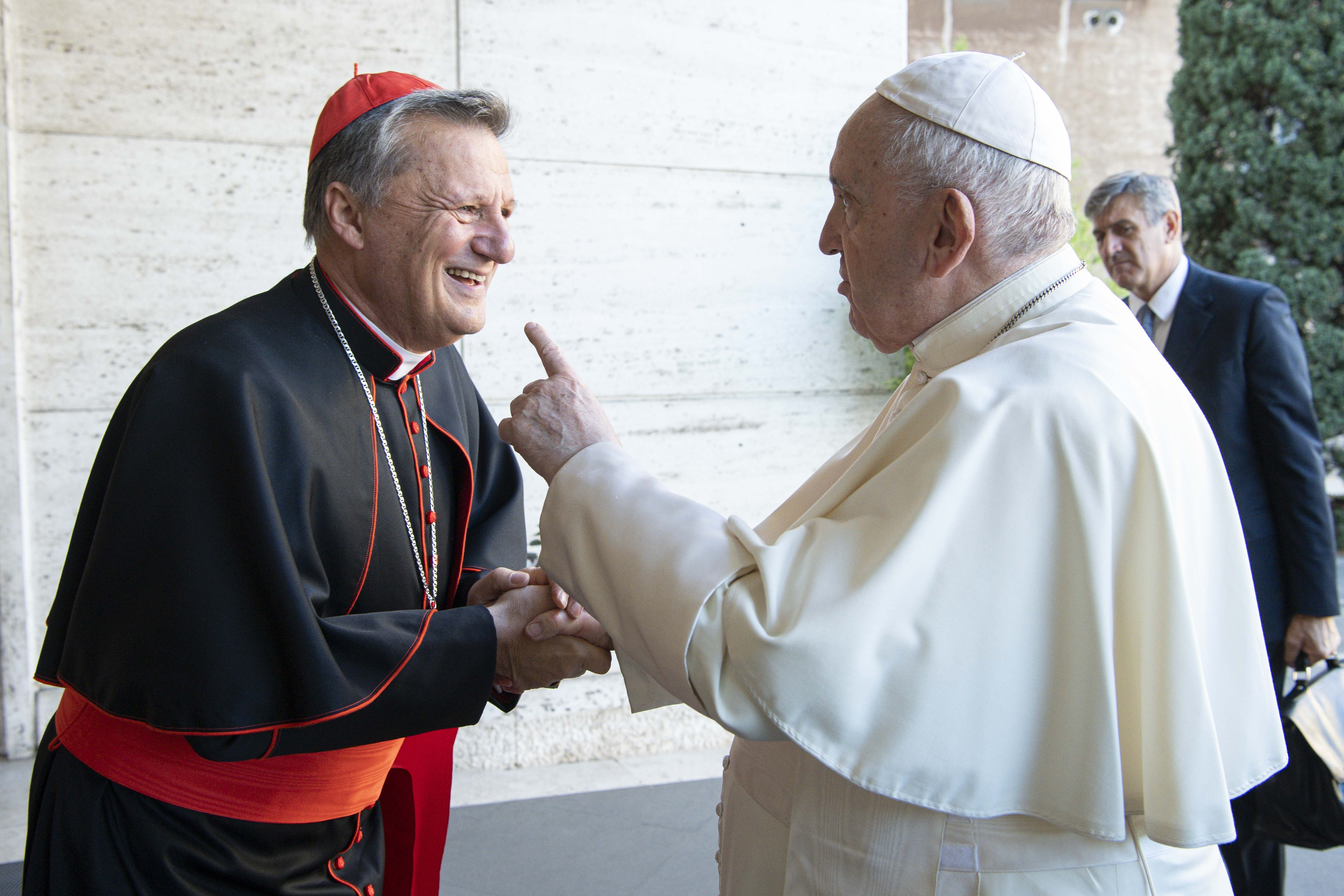 Pope Francis greets Maltese Cardinal Mario Grech, secretary-general of the Synod of Bishops, during a meeting with representatives of bishops' conferences from around the world at the Vatican in this Oct. 9, 2021. (CNS photo/Paul Haring)