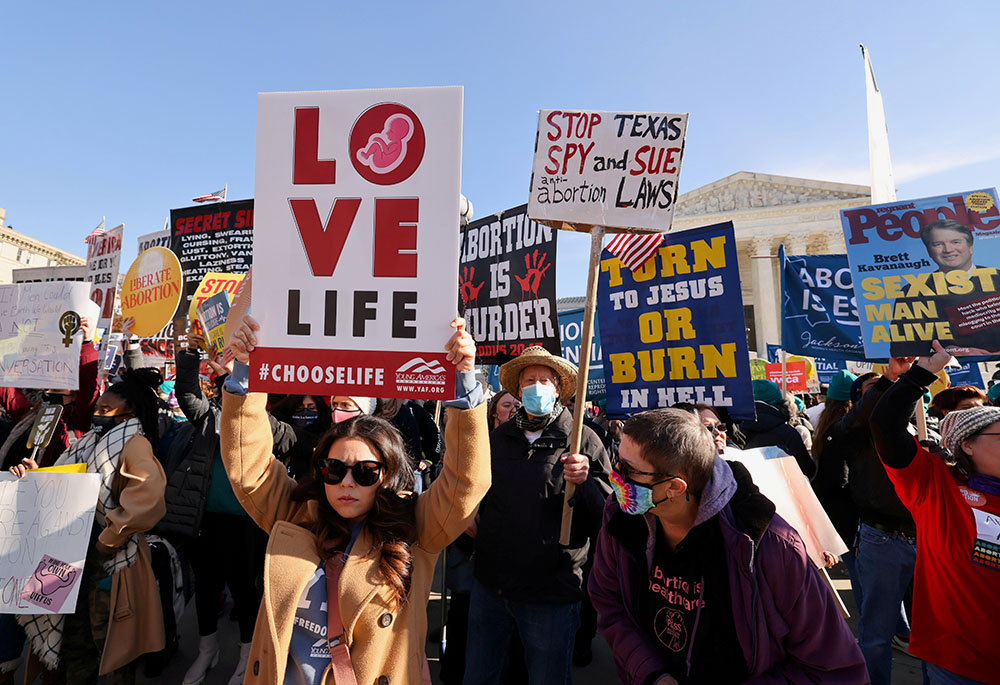 Demonstrators are seen outside the Supreme Court Dec. 1, 2021, ahead of oral arguments in Dobbs v. Jackson Women's Health, a case involving Mississippi's law banning most abortions after 15 weeks. (CNS/Reuters/Evelyn Hockstein)