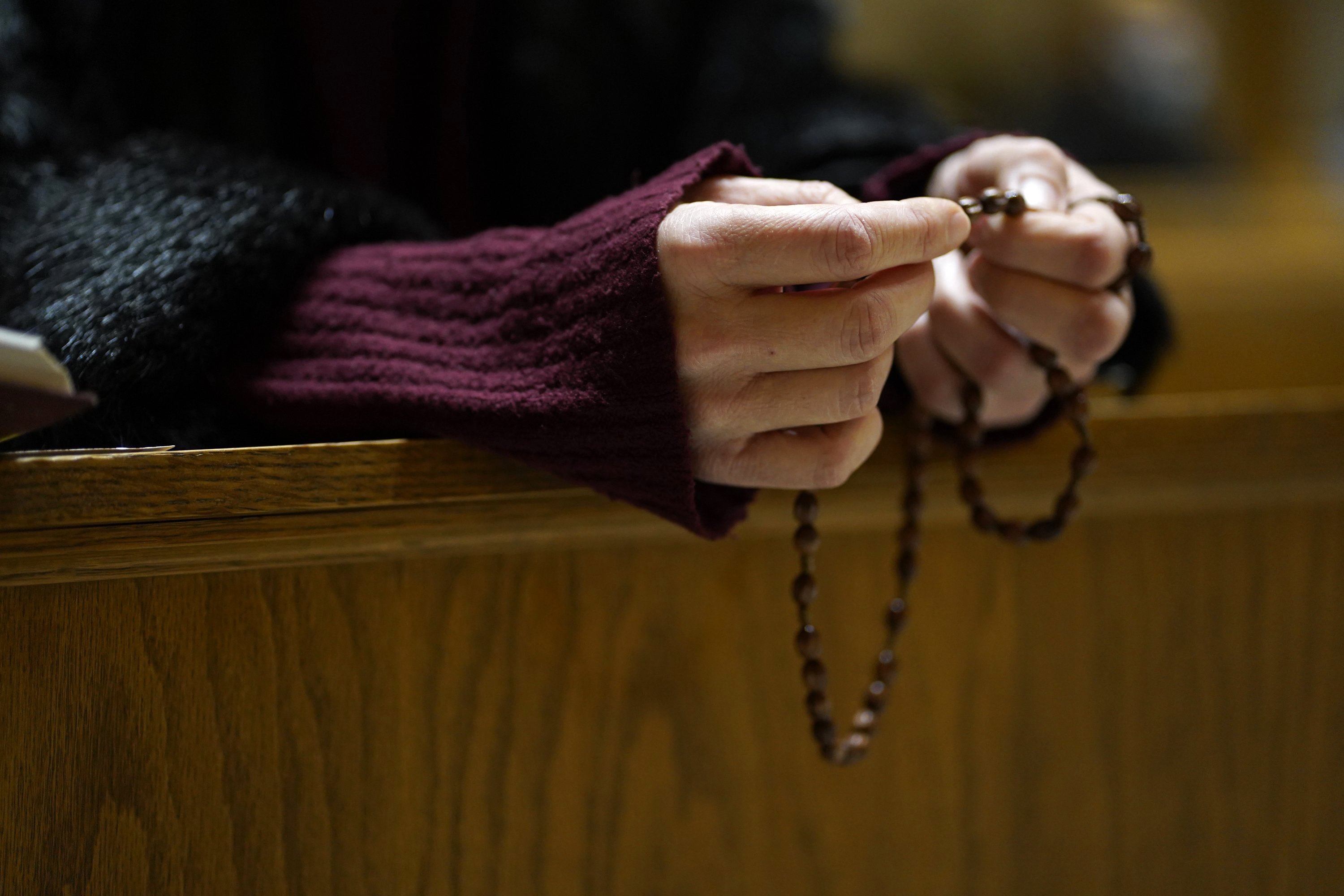 A woman prays the rosary following an evening prayer service at St. George Ukrainian Catholic Church in New York City Jan. 26, 2022. (CNS photo/Gregory A. Shemitz)