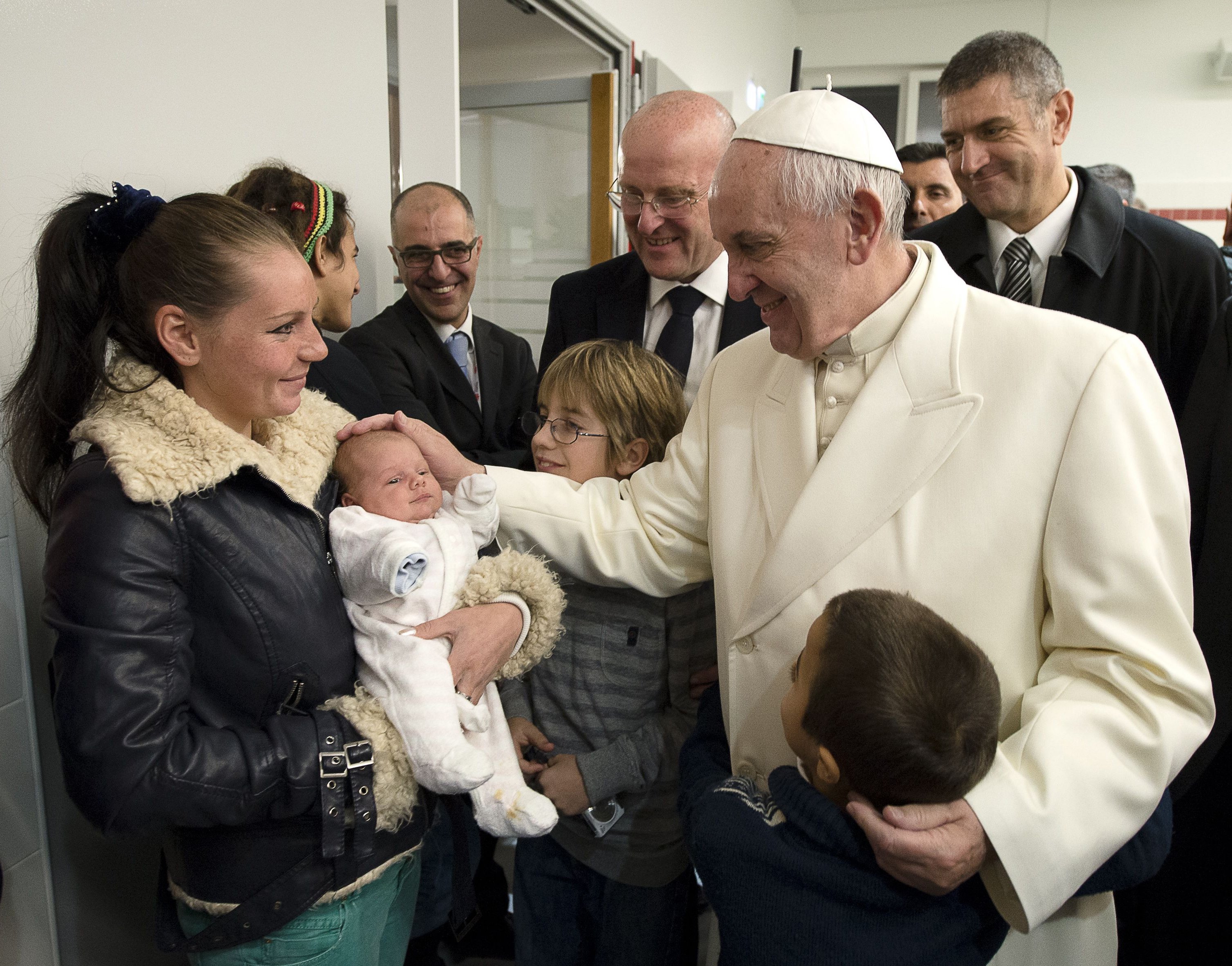 Pope Francis blesses a baby during a visit to a Caritas center for the homeless near the Termini rail station in Rome Dec. 18, 2015. (CNS photo/L'Osservatore Romano, handout)