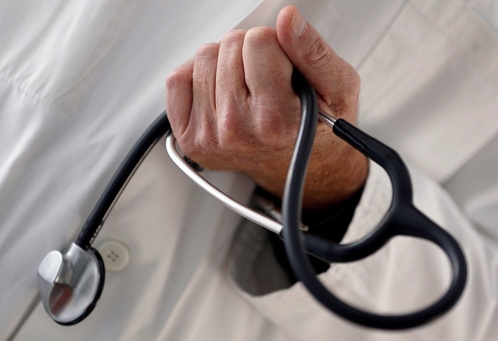 A doctor holds a stethoscope in this illustration photo. (CNS/Reuters/Regis Duvignau)