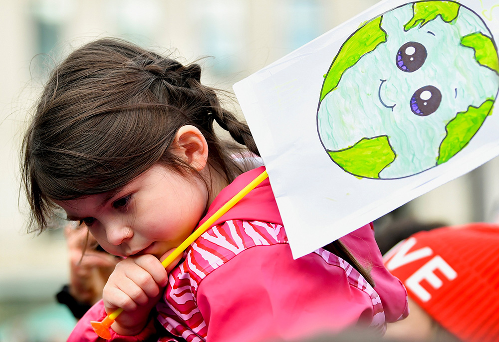 A child in Glasgow, Scotland, holds a placard at a "Fridays for Future" march Nov. 5, 2021, during the U.N. Climate Change Conference. (CNS/Reuters/Dylan Martinez) A child in Glasgow, Scotland, holds a placard at a "Fridays for Future" march Nov. 5, 2021, during the U.N. Climate Change Conference. (CNS/Reuters/Dylan Martinez)