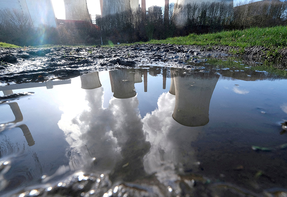 A coal power plant in Neurath, Germany, is seen reflected in a puddle of water Feb. 5, 2020. (CNS/Reuters/Wolfgang Rattay) A coal power plant in Neurath, Germany, is seen reflected in a puddle of water Feb. 5, 2020. (CNS/Reuters/Wolfgang Rattay)