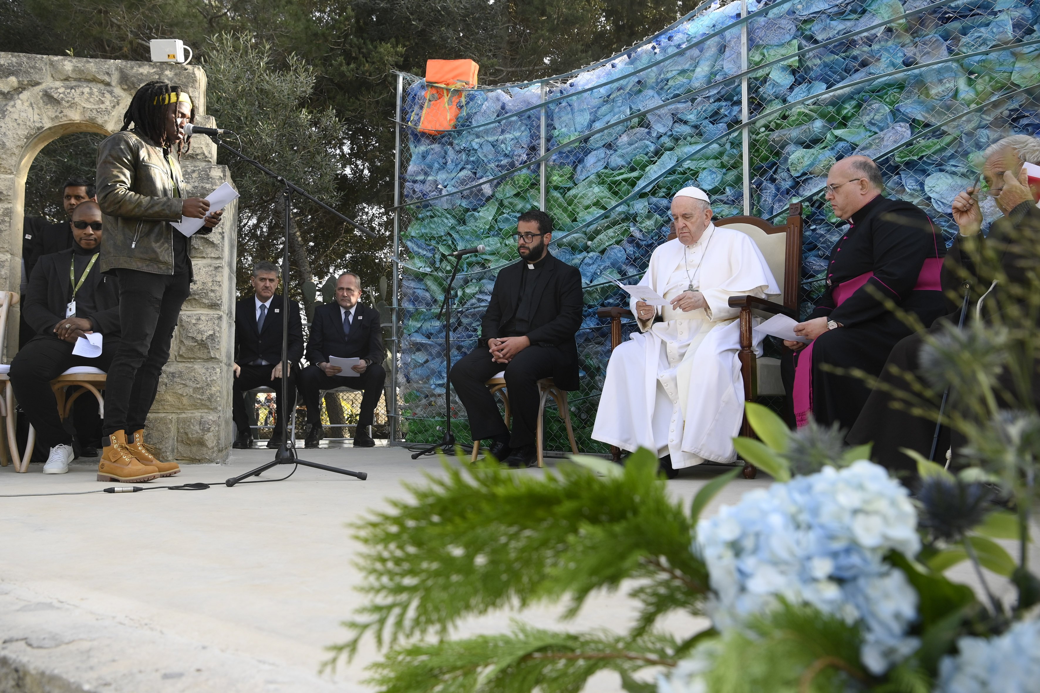 Pope Francis listens as migrant Daniel Jude Oukeguale speaks of his harrowing journey leaving Nigeria, during a meeting with migrants at the John XXIII Peace Lab in Hal Far, Malta, April 3, 2022. (CNS photo/Vatican Media)