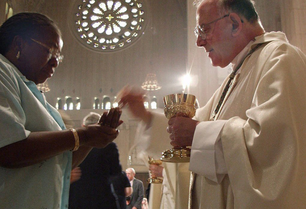 In this 2002 file photo, a woman receives Communion during a special Mass marking the first Eucharistic Congress of the Knights of Columbus at the Basilica of the National Shrine of the Immaculate Conception in Washington. (CNS) In this 2002 file photo, a woman receives Communion during a special Mass marking the first Eucharistic Congress of the Knights of Columbus at the Basilica of the National Shrine of the Immaculate Conception in Washington. (CNS)