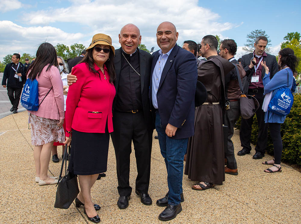 From left: Elisabeth Román, president of the National Catholic Council for Hispanic Ministry; Washington Auxiliary Bishop Mario Dorsonville; and Juan Soto, Gamaliel's organizing director, pose for a photo near the U.S. Capitol in Washington April 27. (CNS