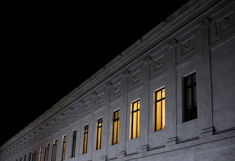 Lights burn inside U.S. Supreme Court offices May 2 in Washington, after the leak of a draft majority opinion written by Justice Samuel Alito preparing for a majority of the court to overturn the Roe v. Wade abortion rights decision later this year. (CNS) Lights burn inside U.S. Supreme Court offices May 2 in Washington, after the leak of a draft majority opinion written by Justice Samuel Alito preparing for a majority of the court to overturn the Roe v. Wade abortion rights decision later this year. (CNS)