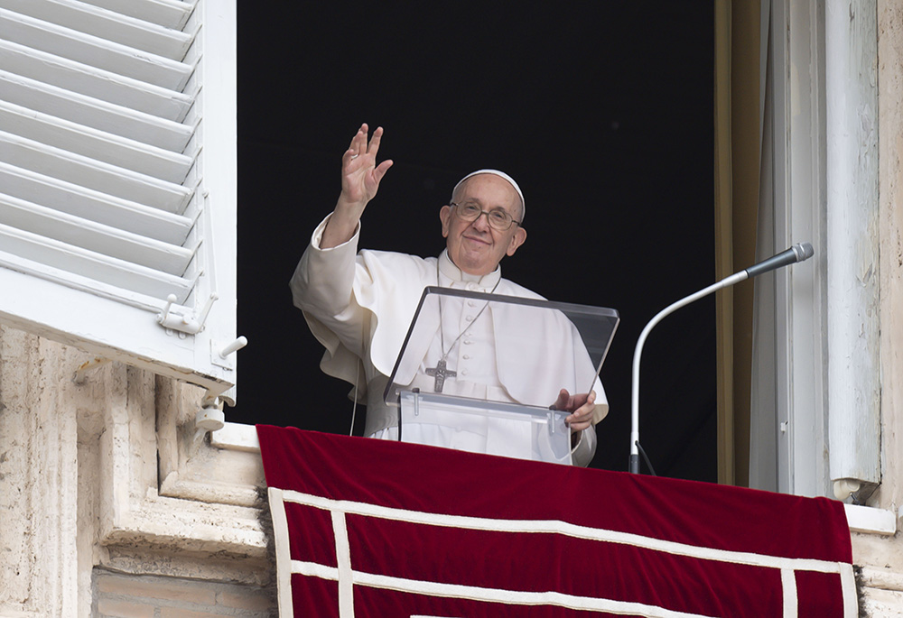 Pope Francis greets the crowd as he leads the "Regina Coeli" prayer from the window of his studio overlooking St. Peter's Square May 8 at the Vatican. (CNS/Vatican Media)