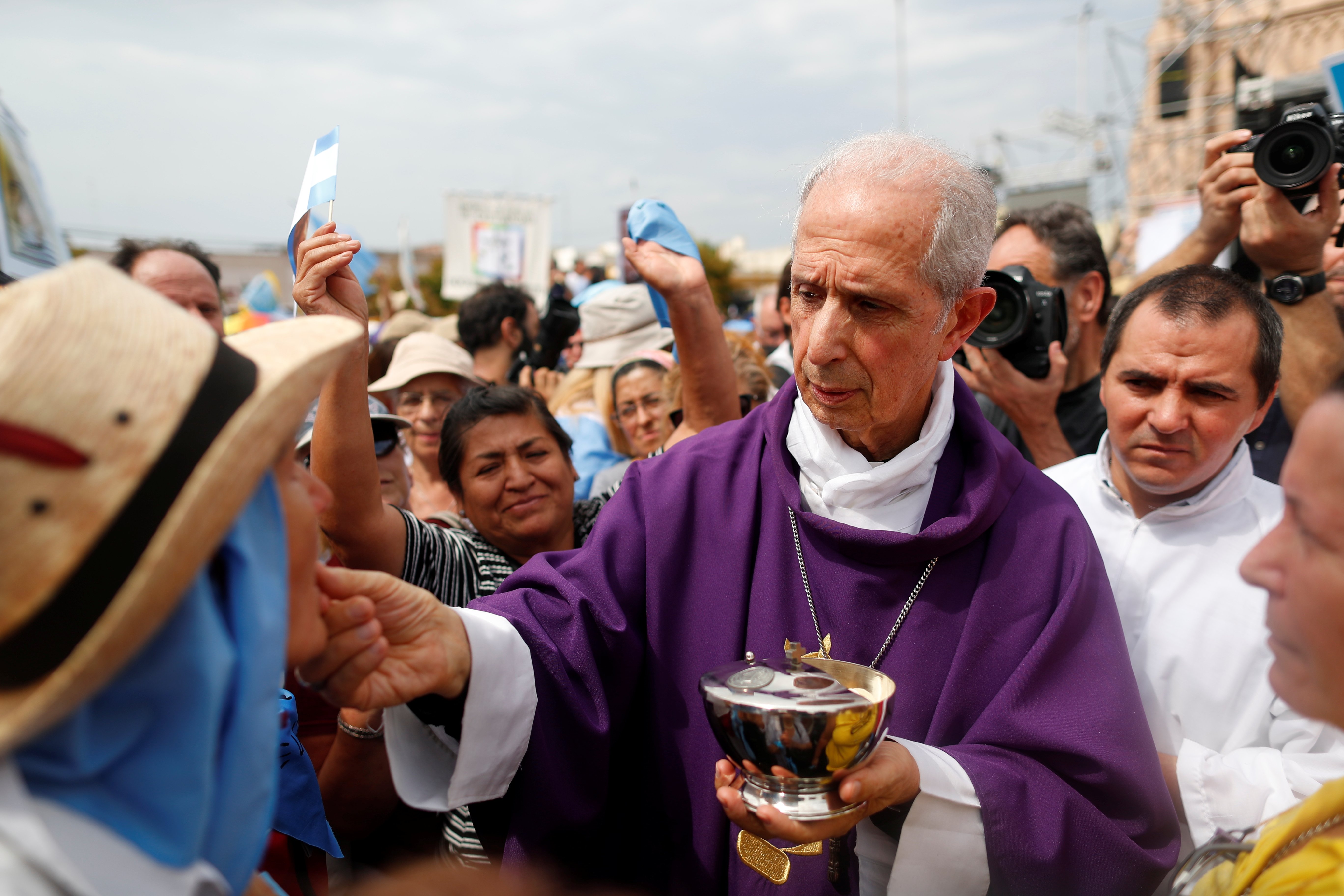 Cardinal Mario Poli of Buenos Aires, Argentina, distributes Communion during a Mass outside the Basilica of Our Lady of Lujan in Buenos Aires March 8, 2020. (CNS photo/Agustin Marcarian, Reuters)