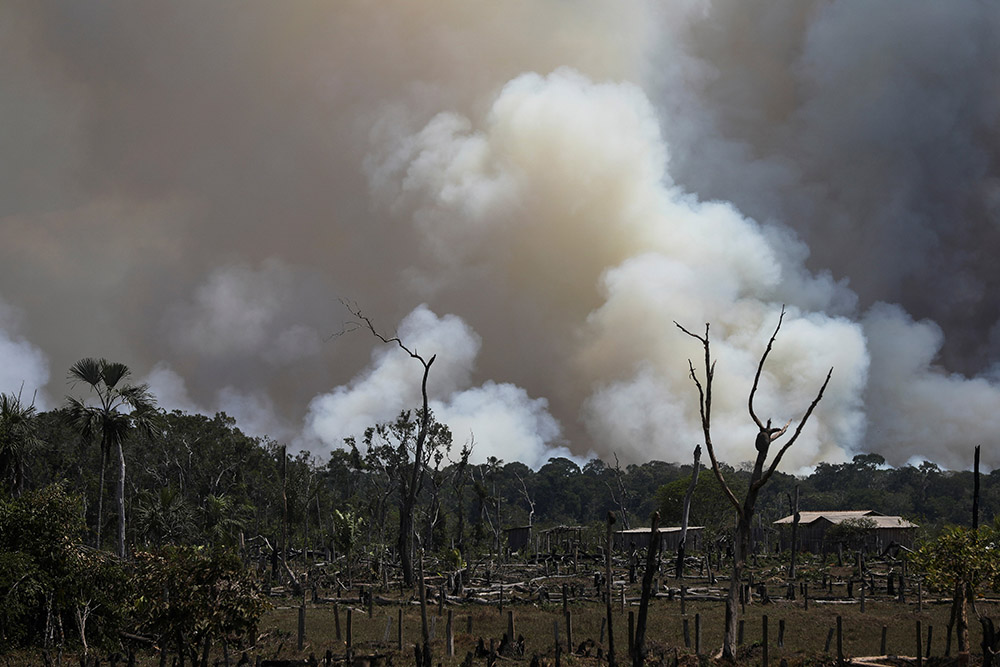 Smoke from burning vegetation rises in the Brazilian Amazon rainforest in Humaita Sept. 8, 2021. (CNS/Reuters/Bruno Kelly)