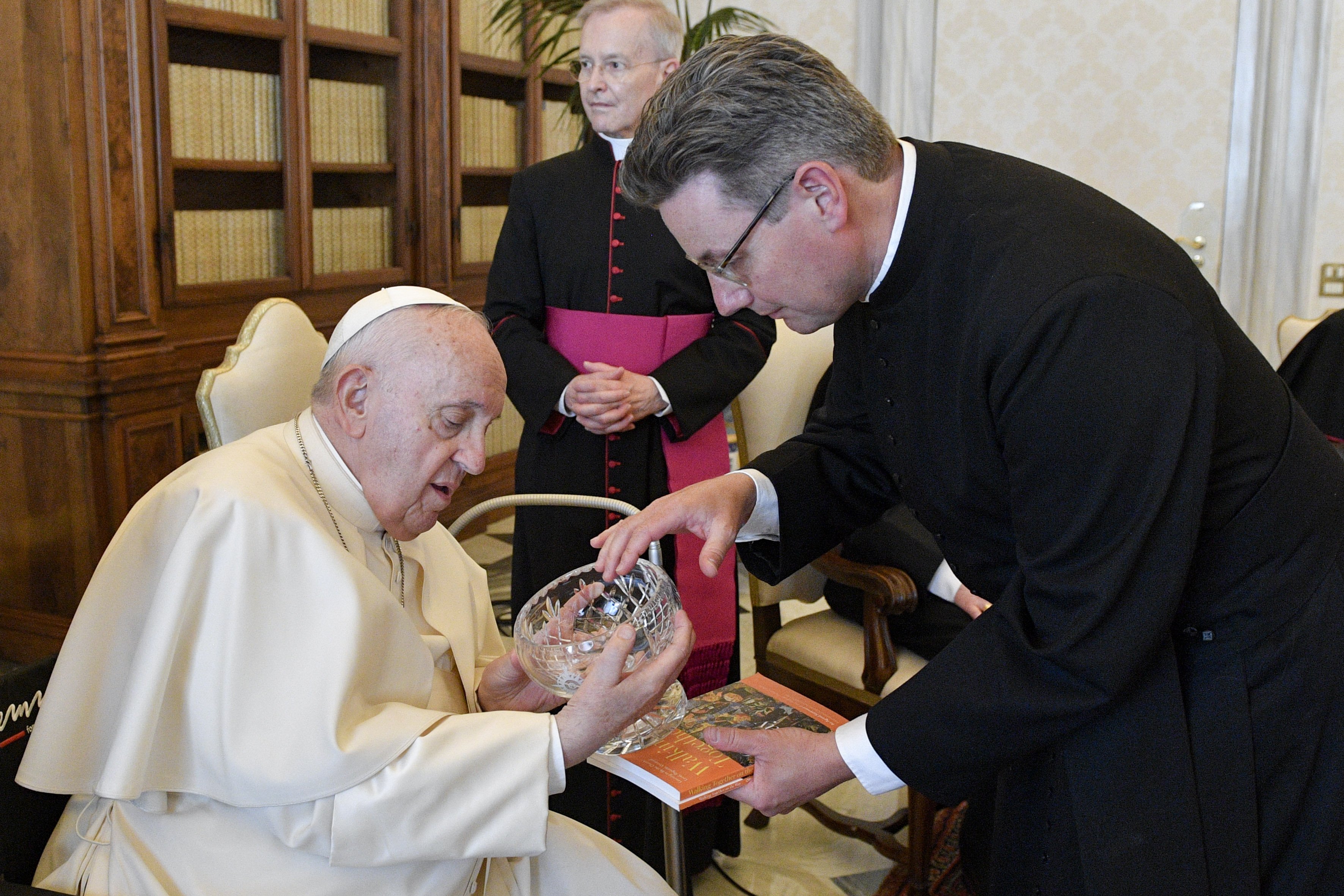The Rev. Will Adam, deputy secretary-general of the Anglican Communion, presents a gift to Pope Francis during a meeting May 13, 2022. (CNS photo/Vatican Media)