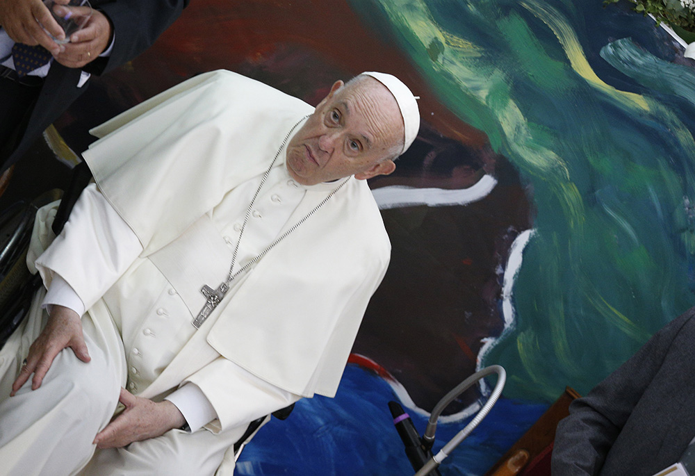 Pope Francis is pictured with his hands near his right knee in this photo shot accidentally during a meeting of Scholas Occurentes May 19 in Rome. The 85-year-old pope has been experiencing severe pain in his right knee for months. (CNS/Paul Haring) Pope Francis is pictured with his hands near his right knee in this photo shot accidentally during a meeting of Scholas Occurentes May 19 in Rome. The 85-year-old pope has been experiencing severe pain in his right knee for months. (CNS/Paul Haring)