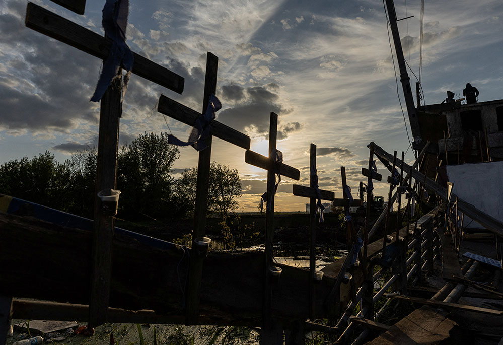 Crosses are attached to the destroyed bridge in Irpin, Ukraine, May 16, during Russia's invasion of Ukraine. (CNS/Reuters/Jorge Silva)