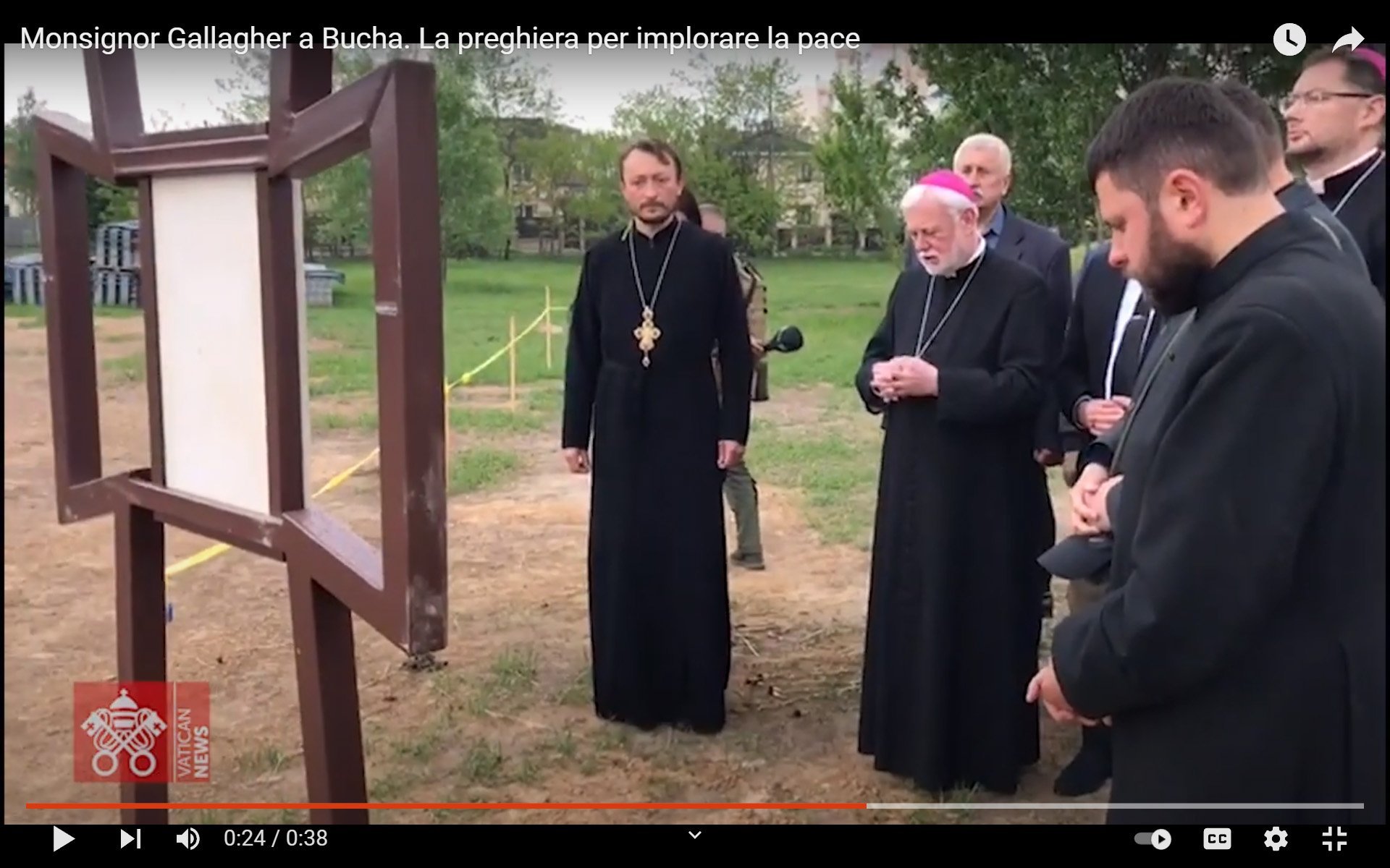 Archbishop Paul R. Gallagher, Vatican foreign minister, prays at the site of a mass grave near the Orthodox Church of St. Andrew in Bucha, Ukraine, May 20, 2022, in this still image taken from video posted by the Vatican. (CNS photo/Vatican Media)