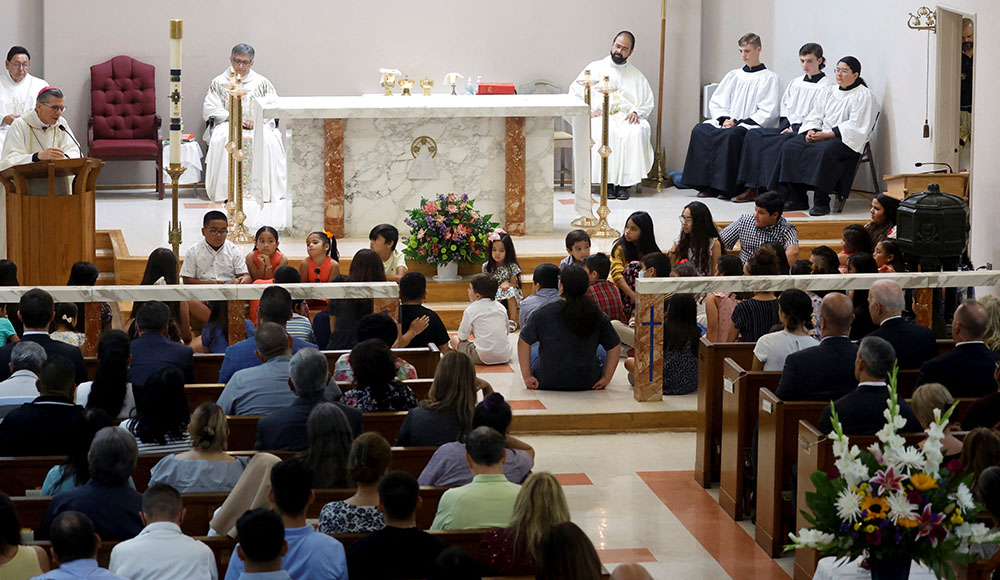 Children at Sacred Heart Catholic Church in Uvalde, Texas, attend Mass with President Joe Biden and first lady Jill Biden May 29. A gunman killed 19 children and two teachers at Robb Elementary School May 24. (CNS/Reuters/Jonathan Ernst)
