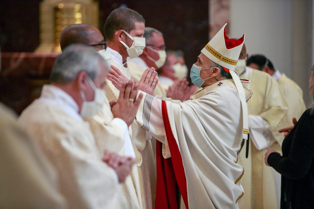 Cardinal Daniel DiNardo of Galveston-Houston greets newly ordained Deacon Bruce Flagg during an ordination Mass for permanent deacons at the Co-Cathedral of the Sacred Heart in Houston Feb. 20, 2021. (CNS/Texas Catholic Herald/James Ramos)